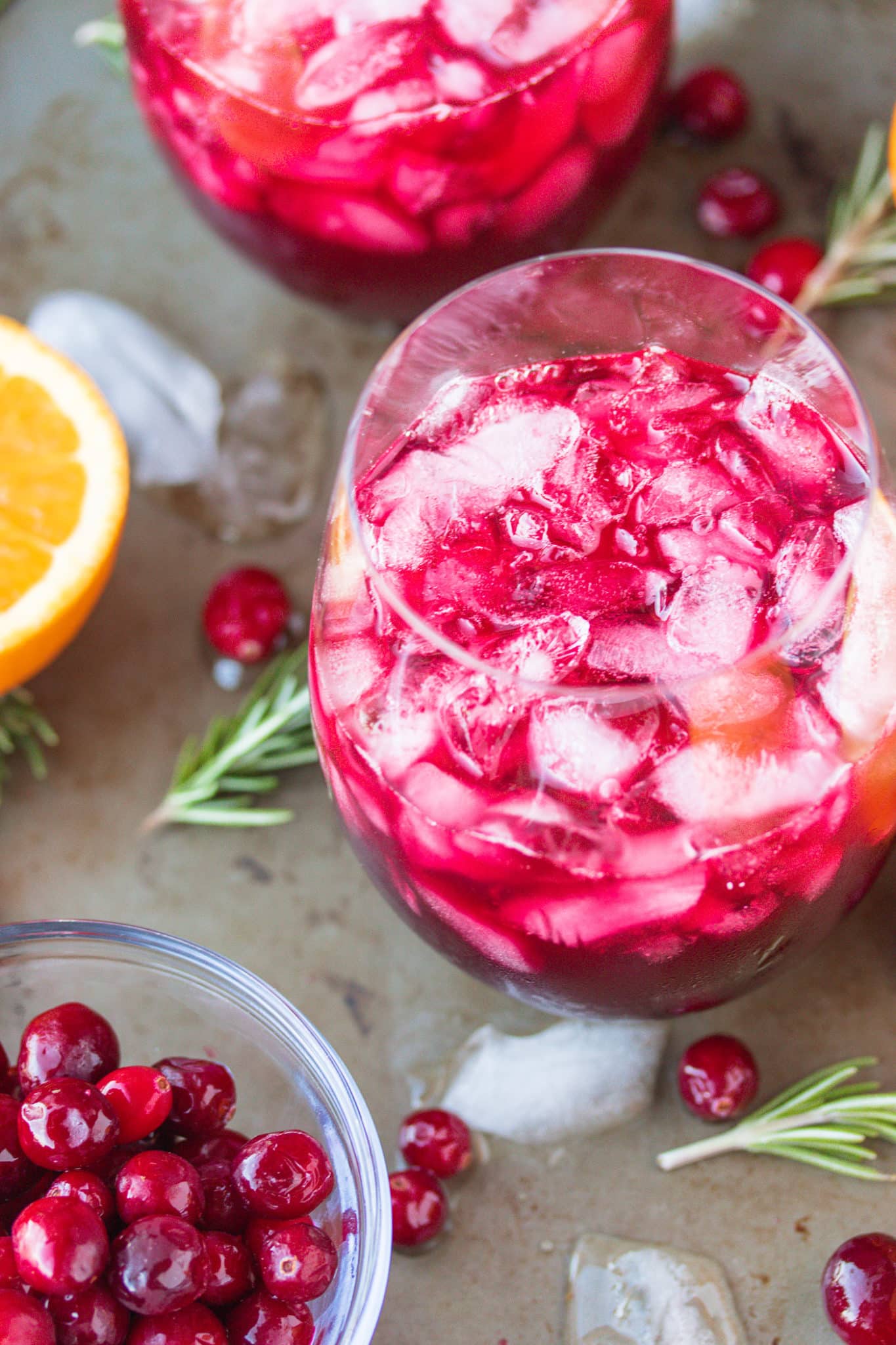 pomegranate cranberry mocktail served with fresh cranberries and orange slices