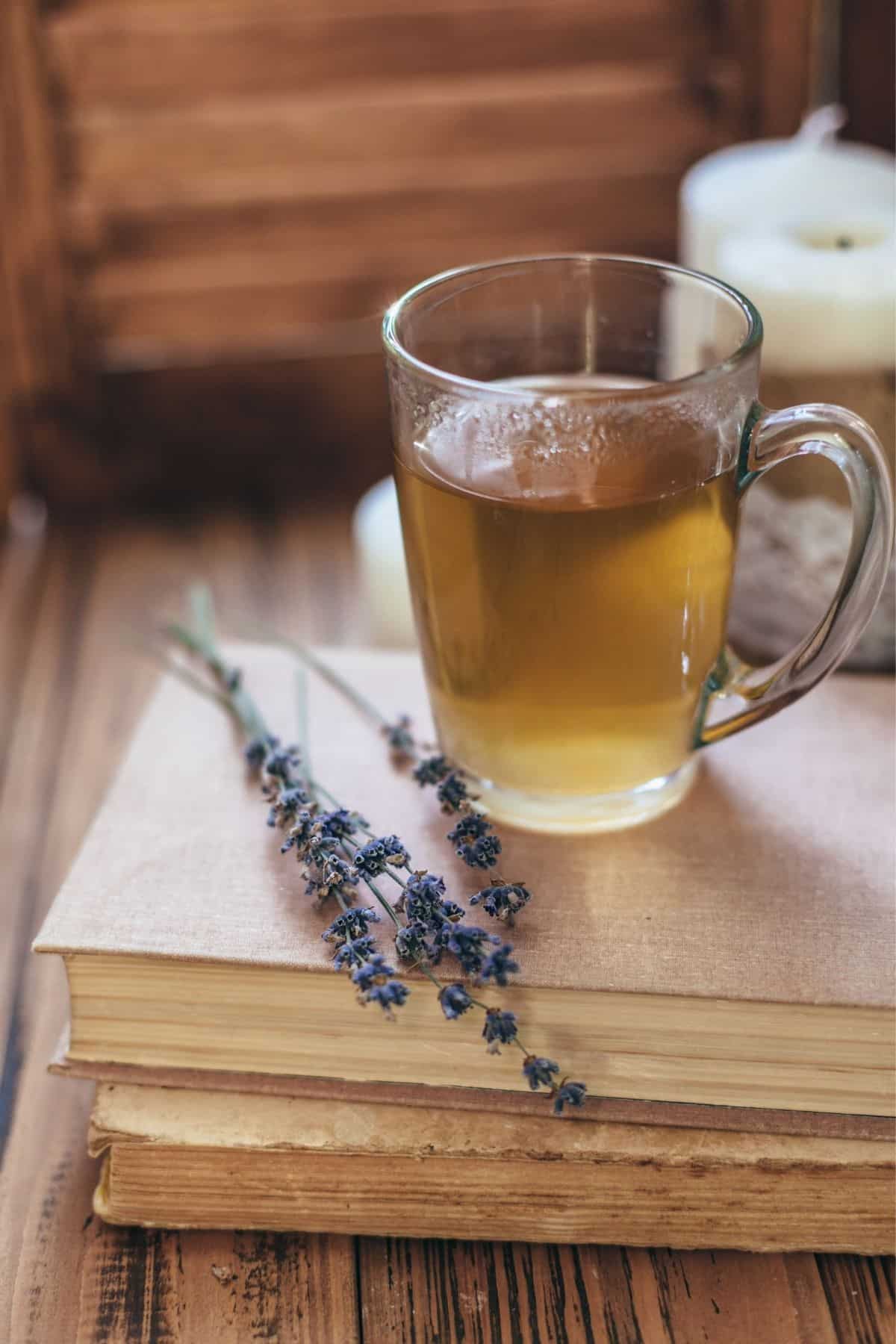 glass of lavender herbal tea on a desk.