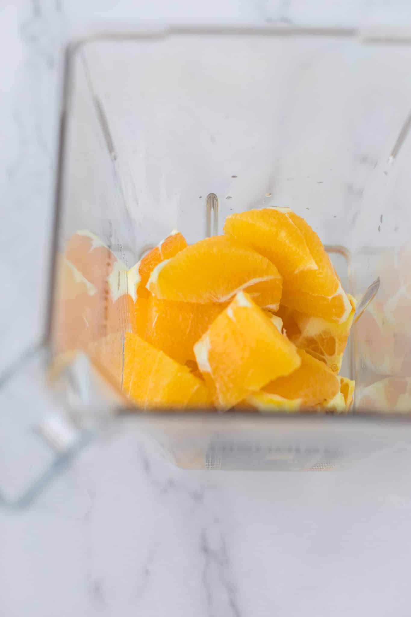 peeled oranges in a high speed blender ready to be blended