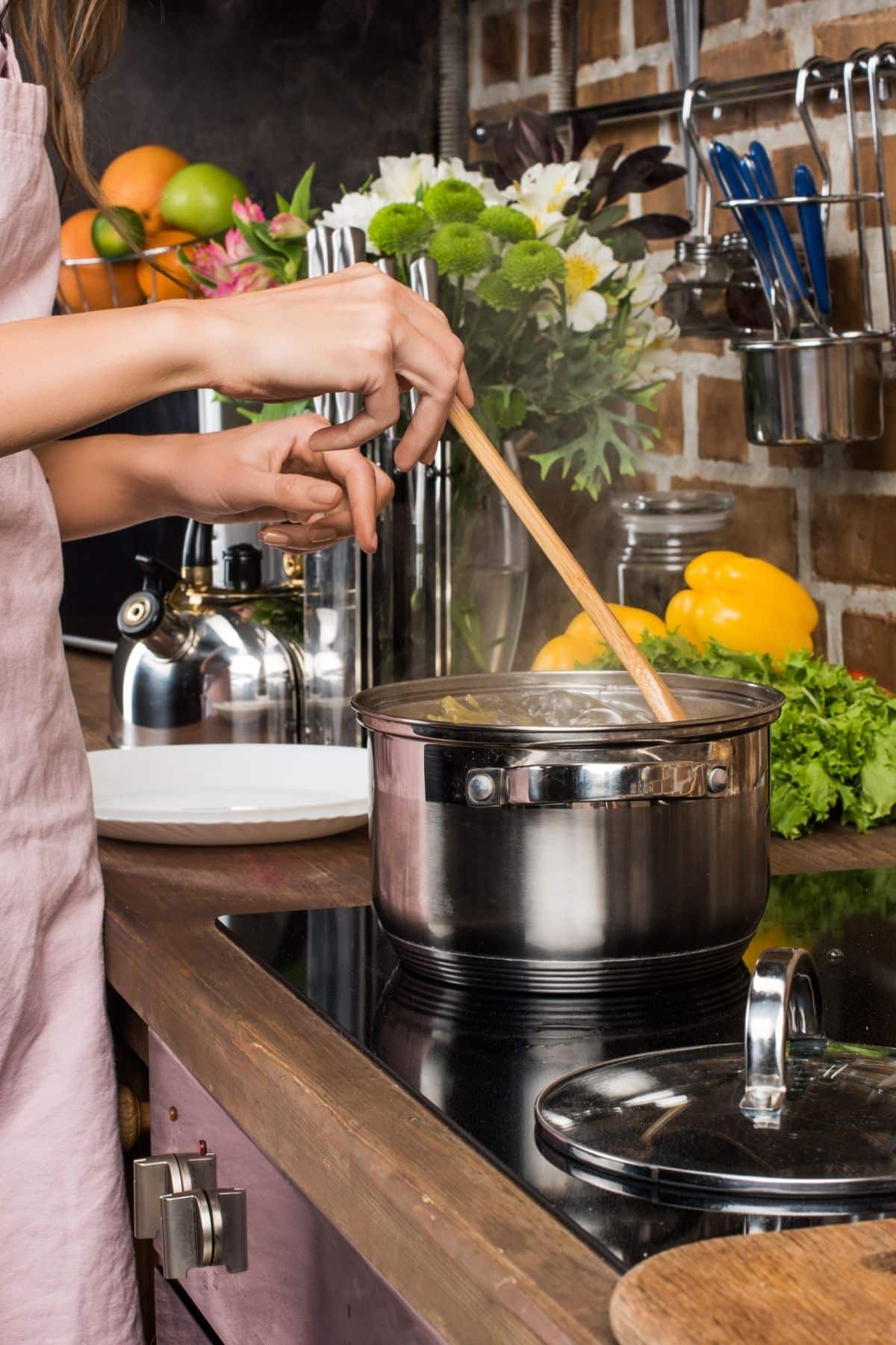 woman stirring a pot in a kitchen