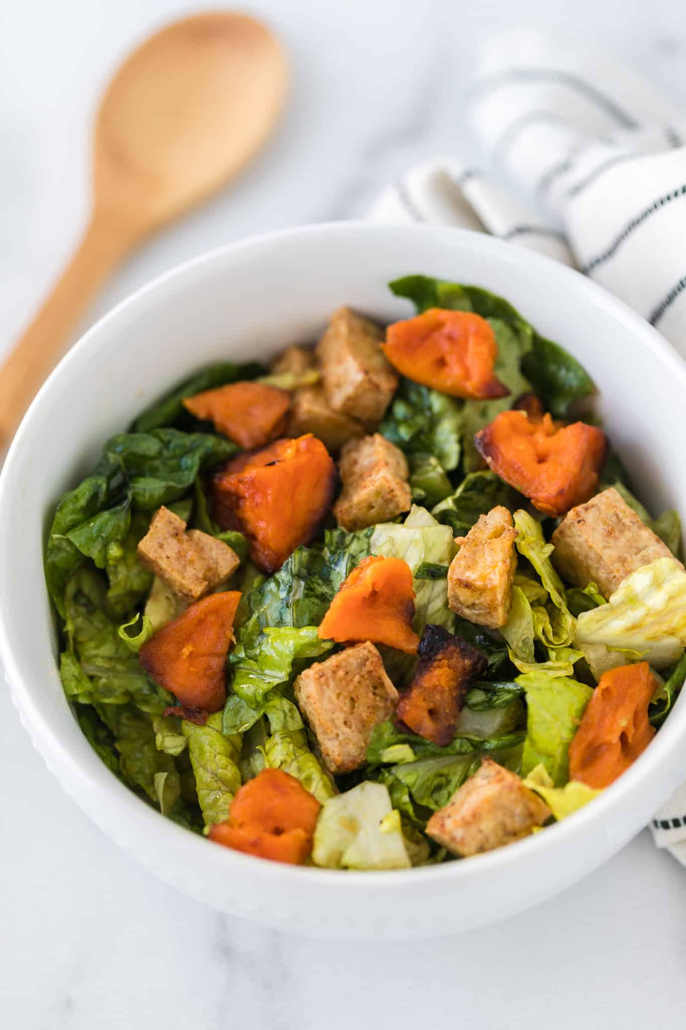 crispy tofu served on a salad with butternut squash