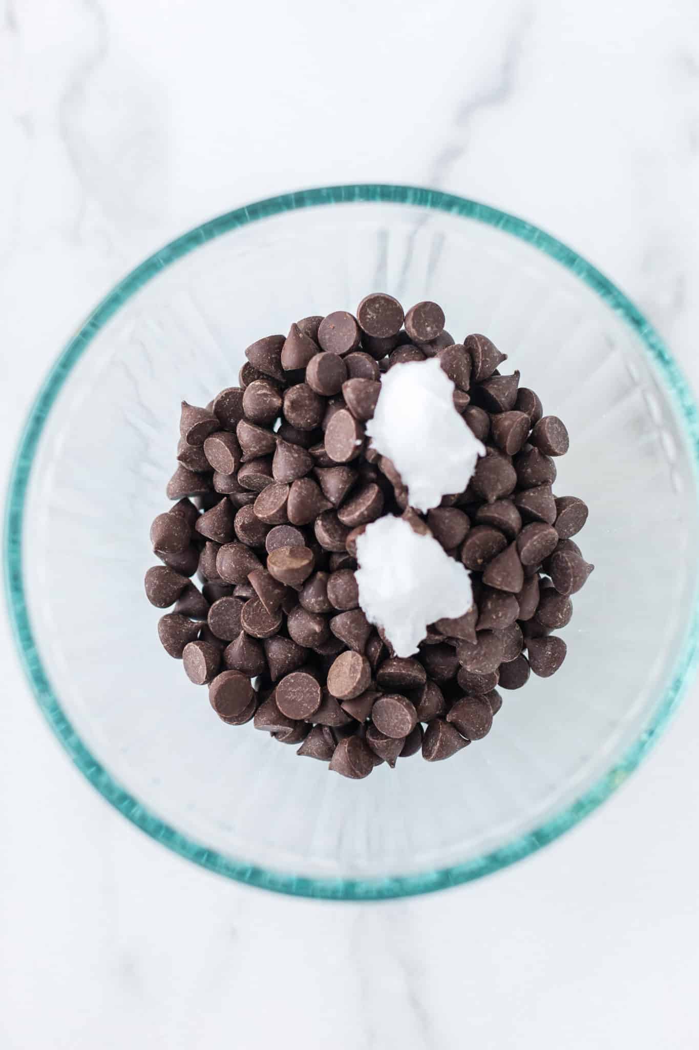 chocolate chips and coconut oil in a glass bowl