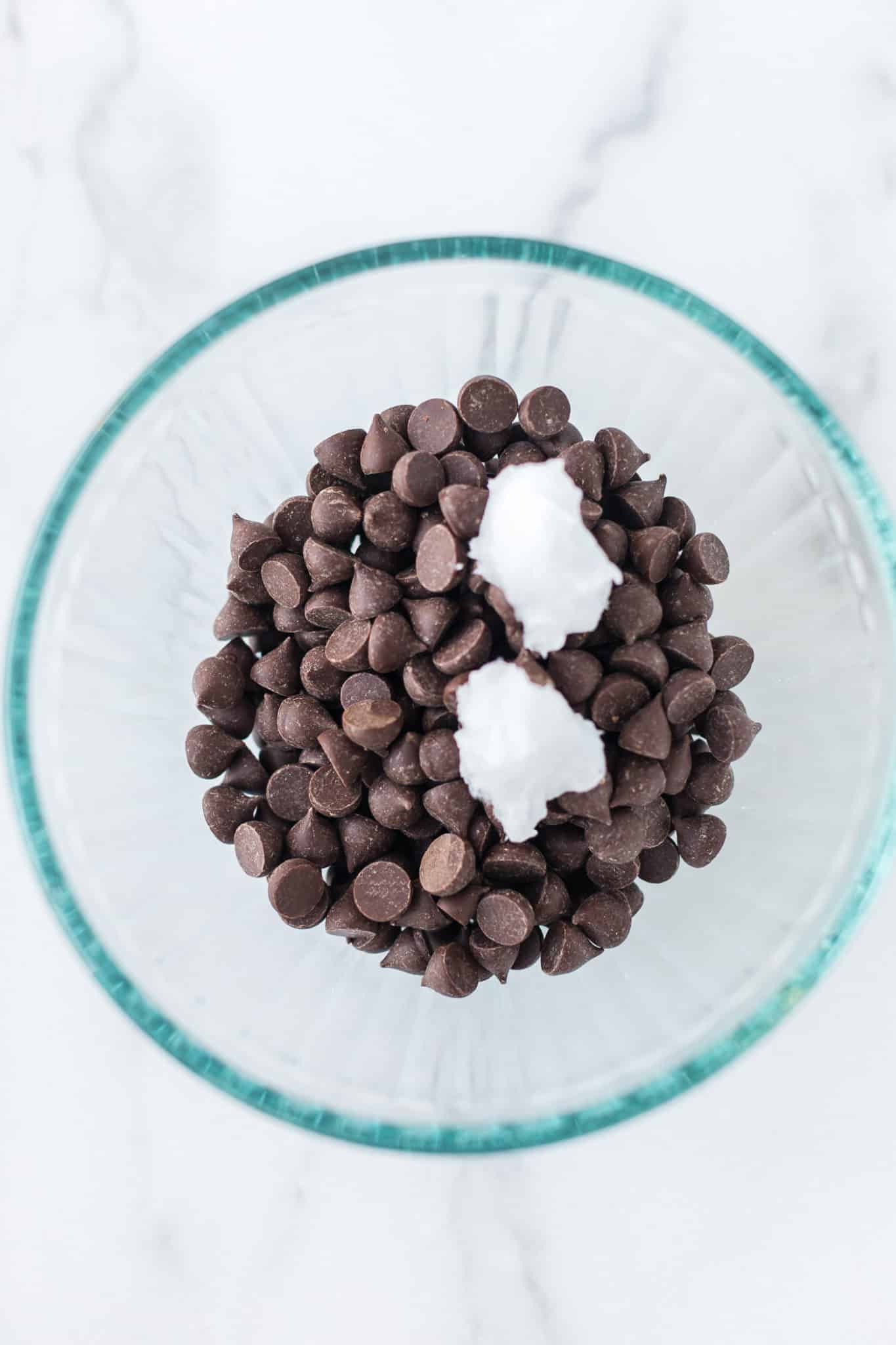 chocolate chips and coconut oil in a glass bowl.