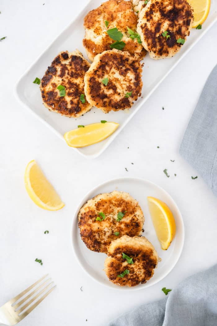 gluten-free crab cakes served with fresh parsley and lemon slices
