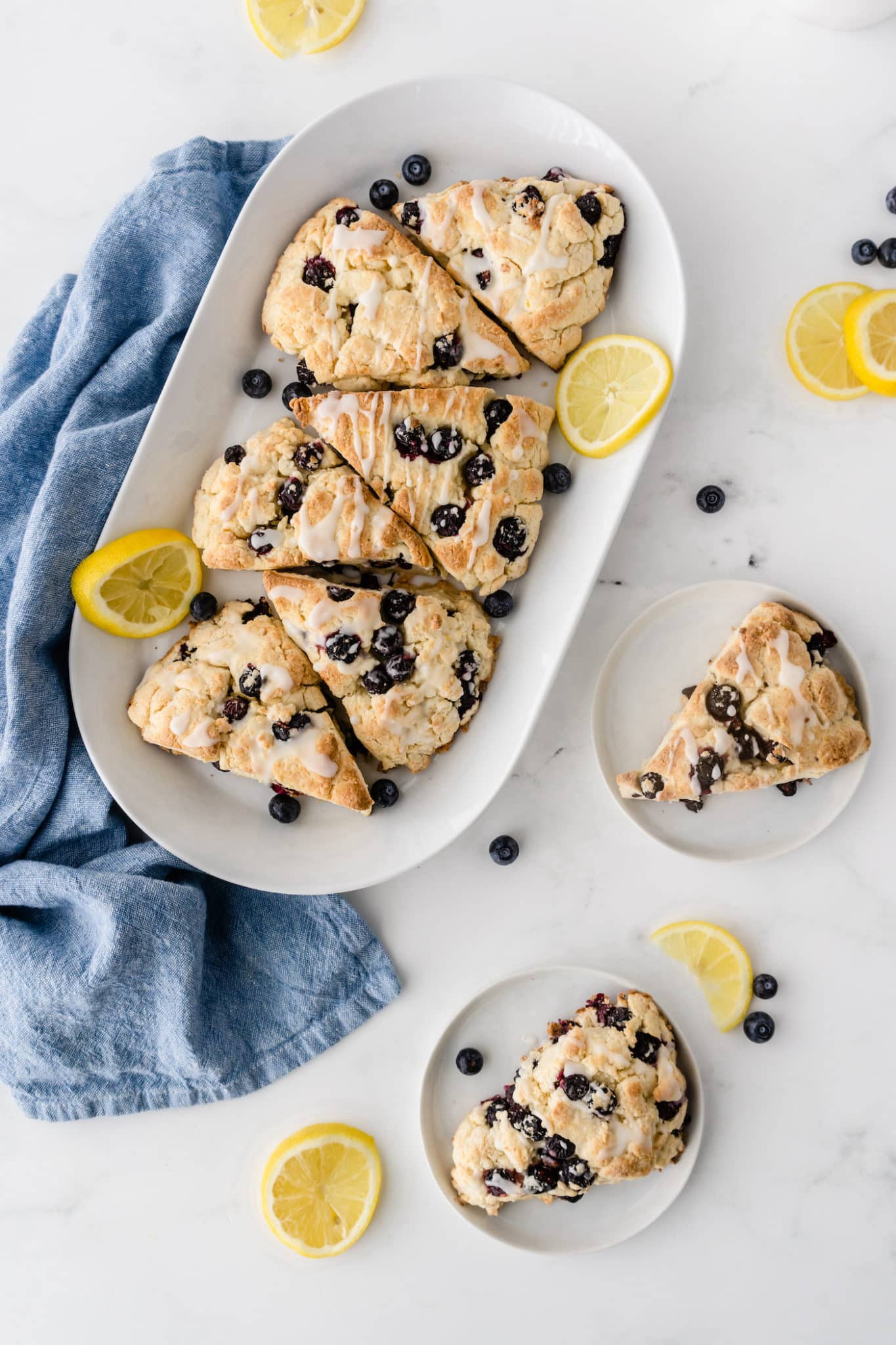 platter of baked gluten-free scones with fresh lemon slices.