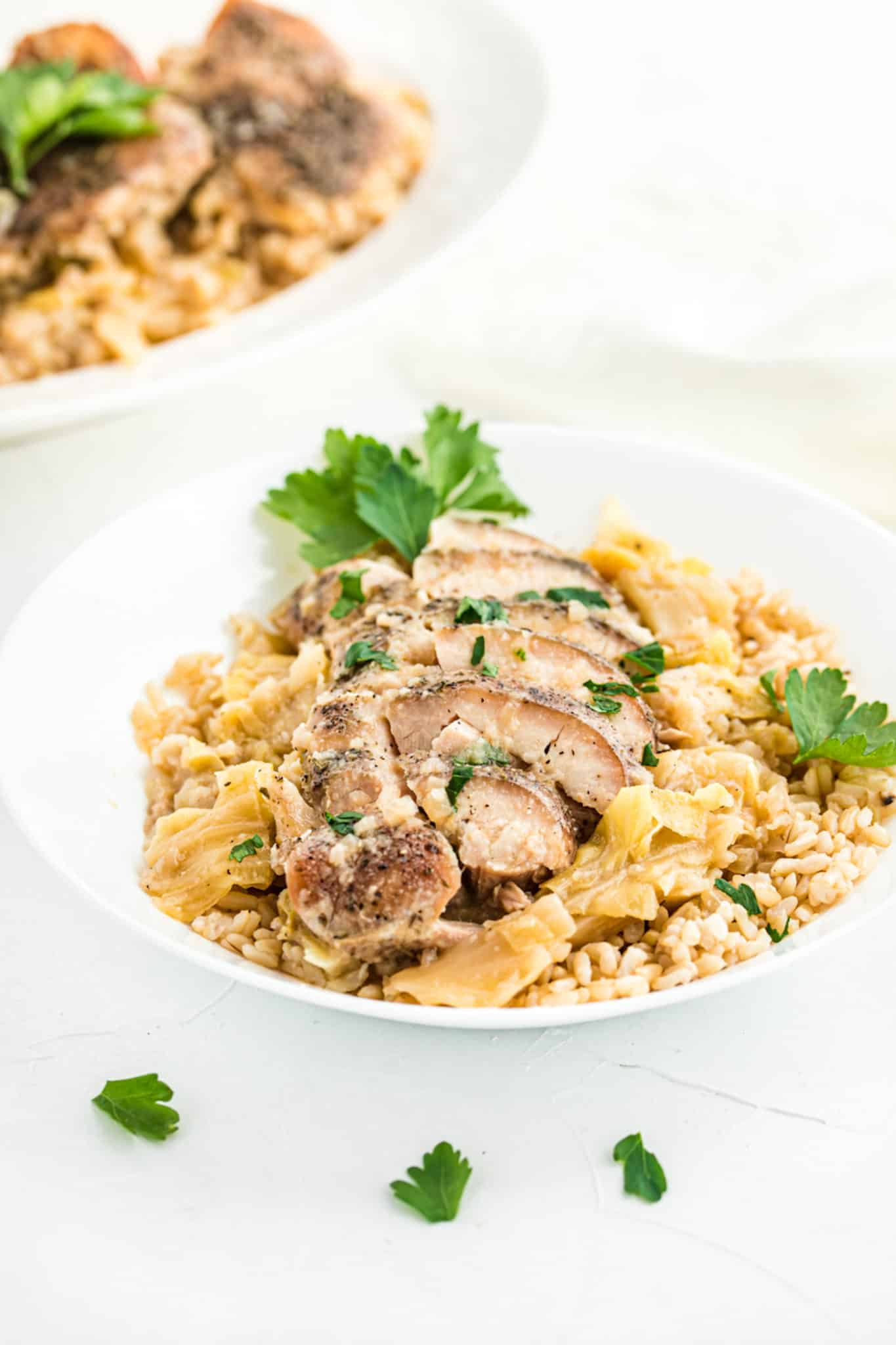 keto chicken thighs served with cooked cabbage and cauliflower rice.