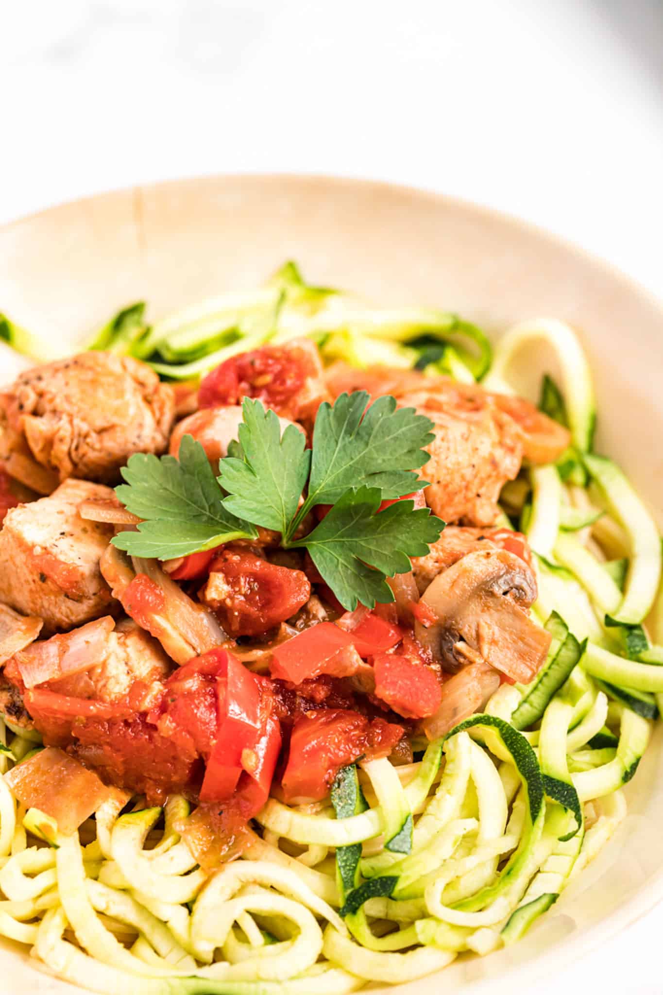 cooked chicken cacciatore served over steamed zucchini noodles.