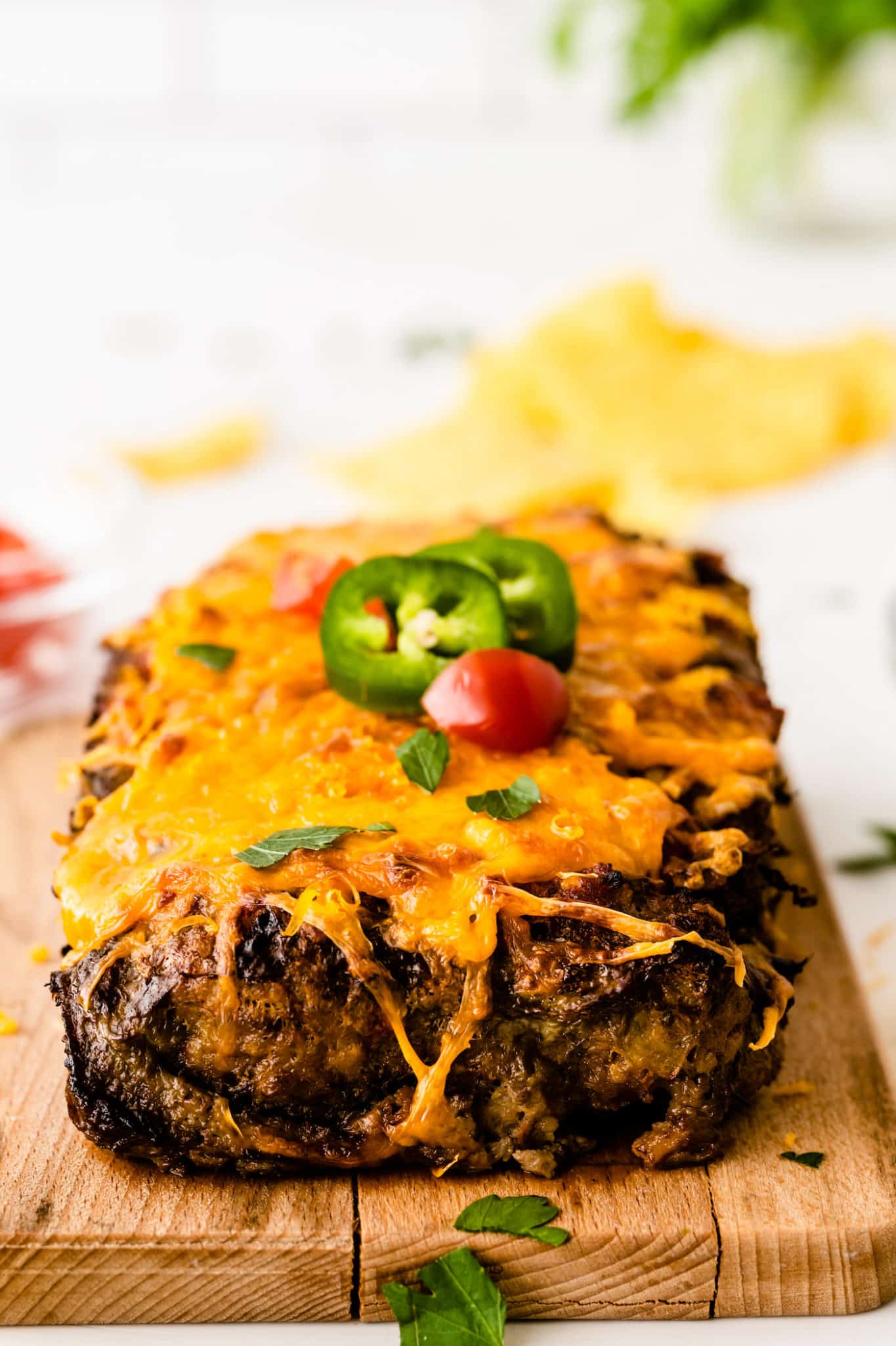 front view of the cooked taco meatloaf with cheese and jalapeño slices on top.