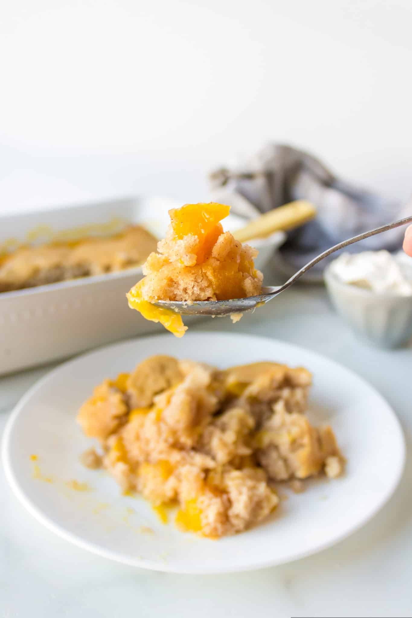 spoonful of peach cobbler ready to eat