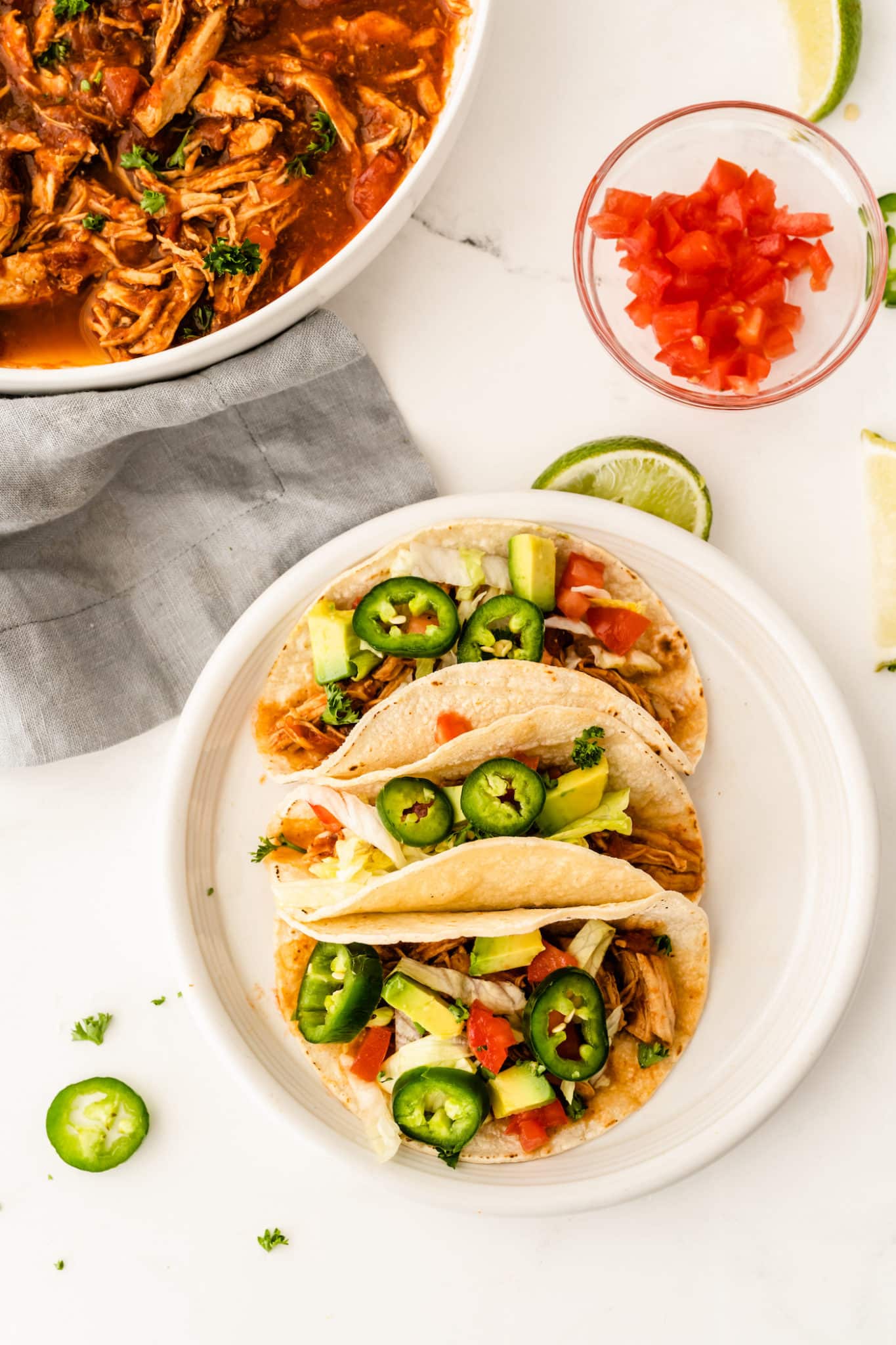 A plate of chicken tinga tacos with jalapenos