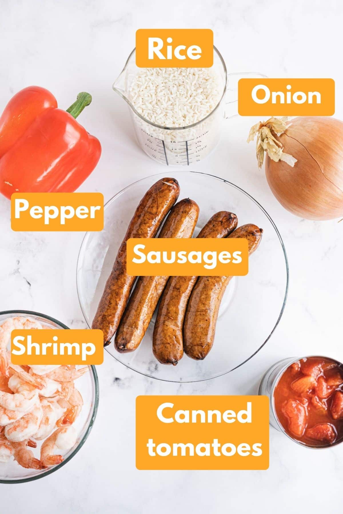 All the ingredients for jambalaya laid out in bowls.