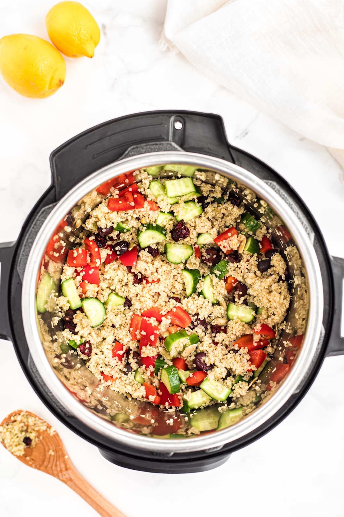 instant pot filled with cooked quinoa and chopped veggies.