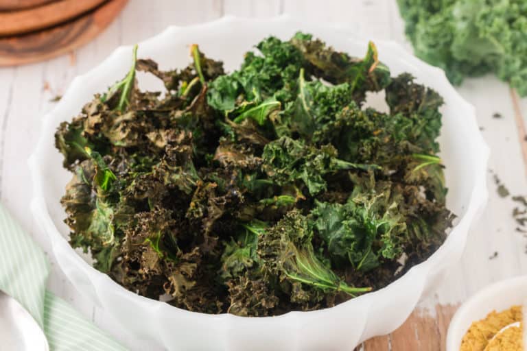 bowl of air fryer kale chips with nutritional yeast.
