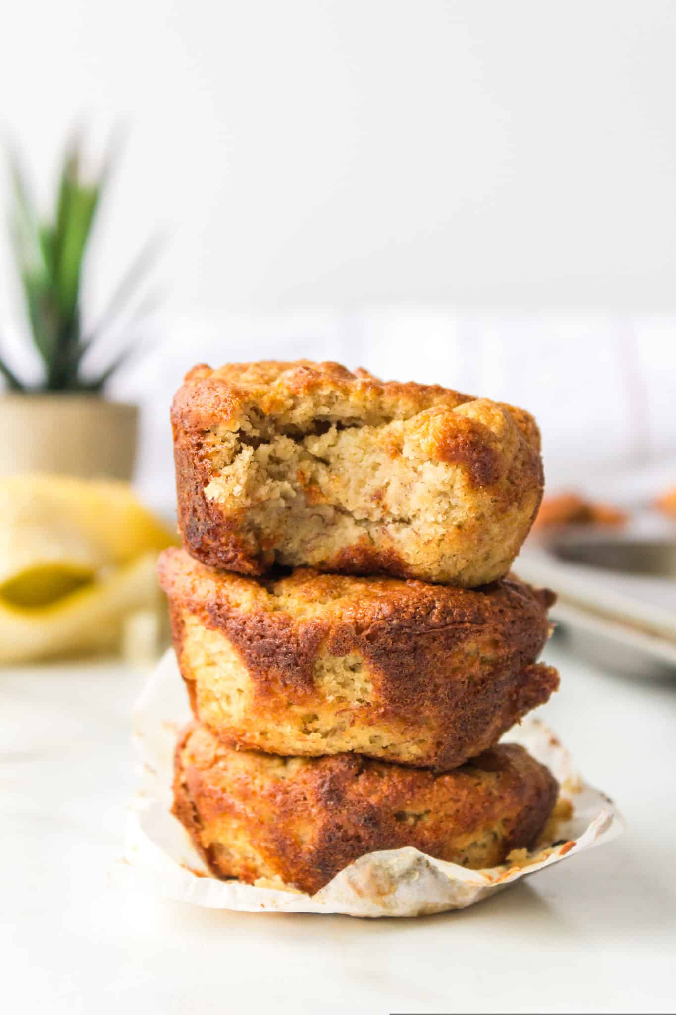 three almond flour banana muffins stacked together