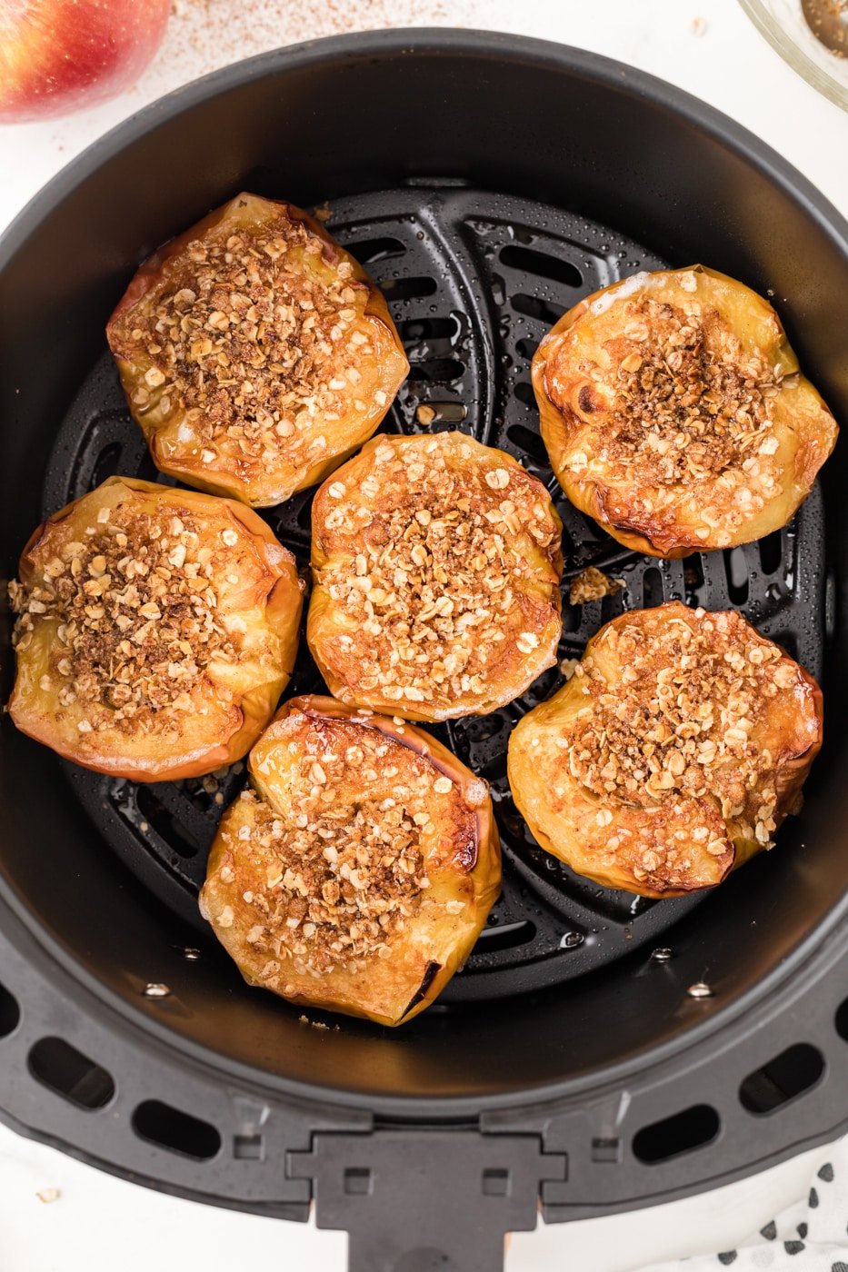 baked apple with oat filling inside an air fryer.