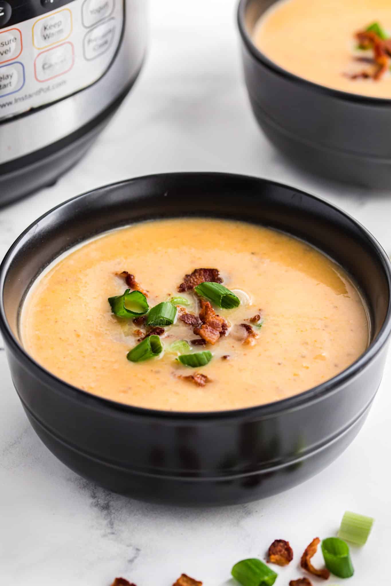 A bowl of dairy-free potato soup topped with bacon crumbles