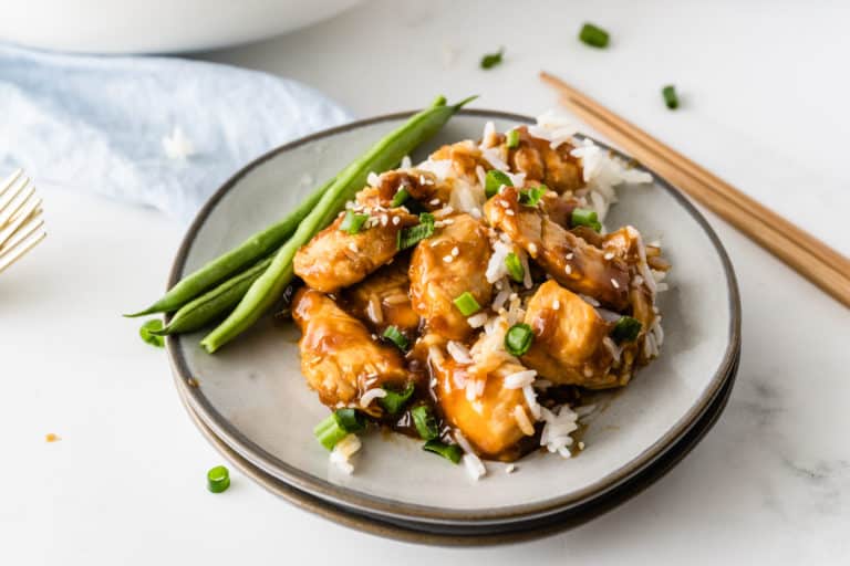 a plate of chicken teriyaki with rice