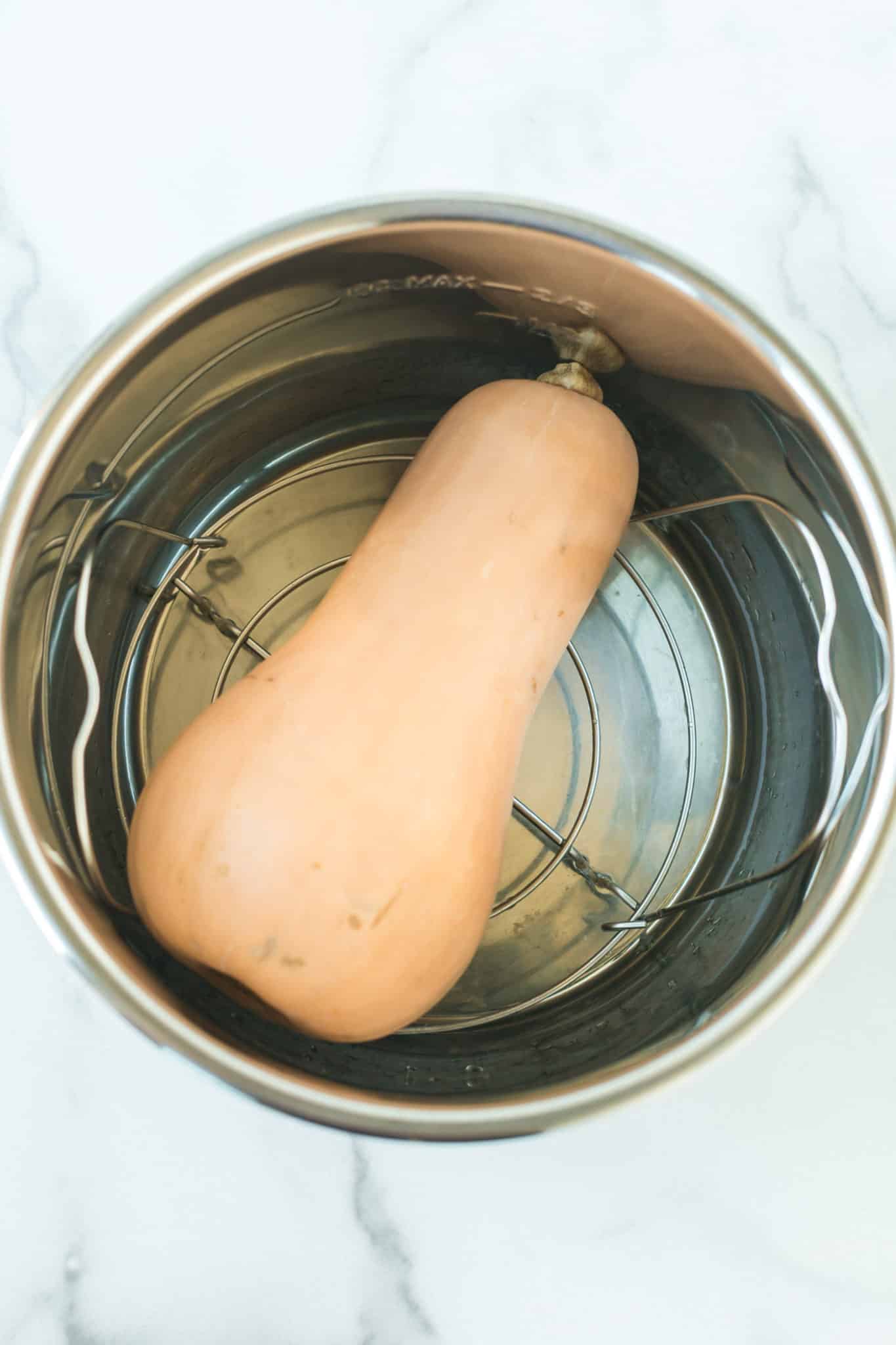 whole butternut squash inside of an instant pot pressure cooker.