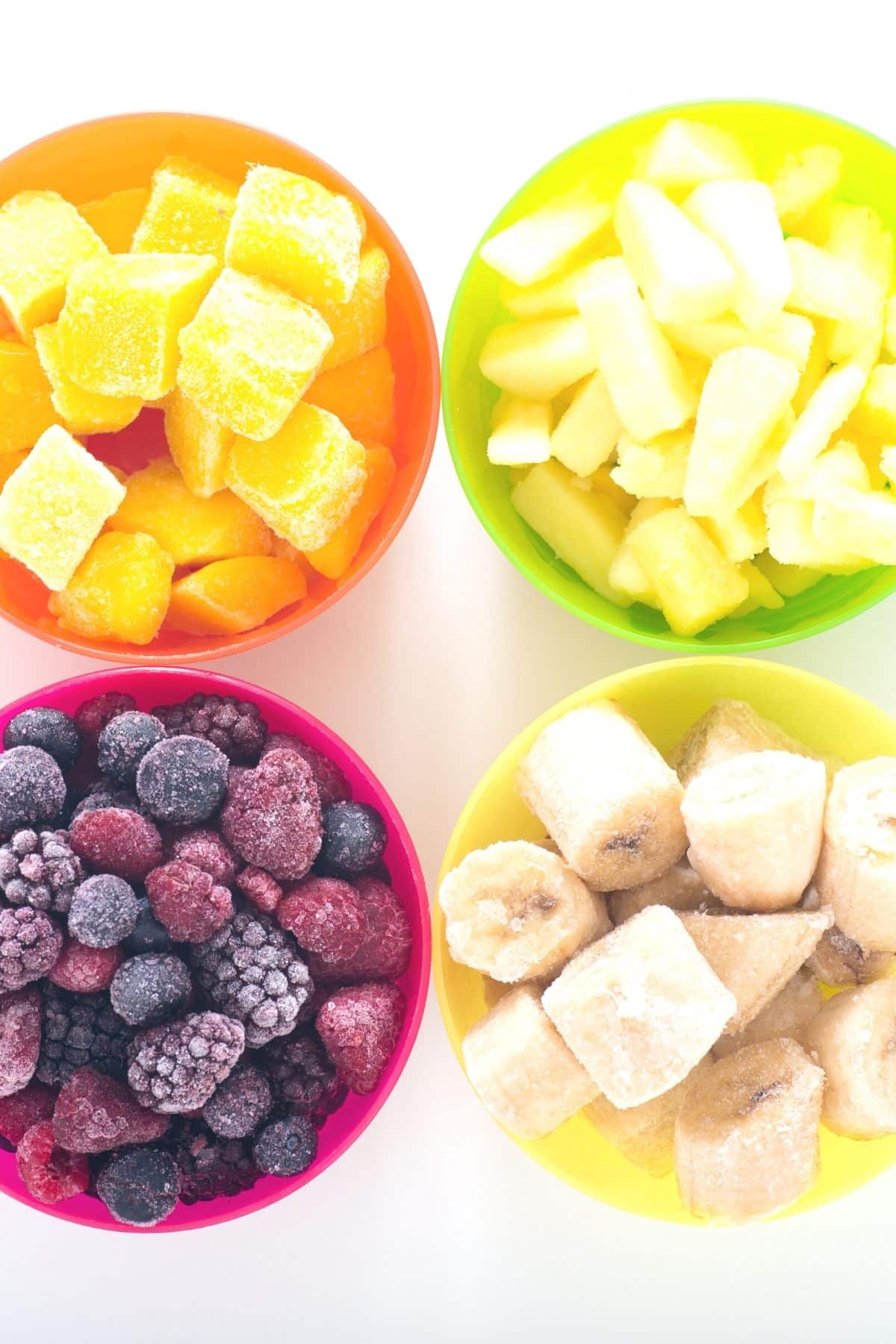 Bowl of frozen bananas, berries, mango, and pineapple