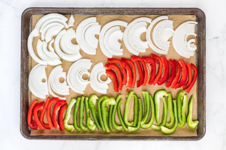 sheet pan of sliced peppers and onions