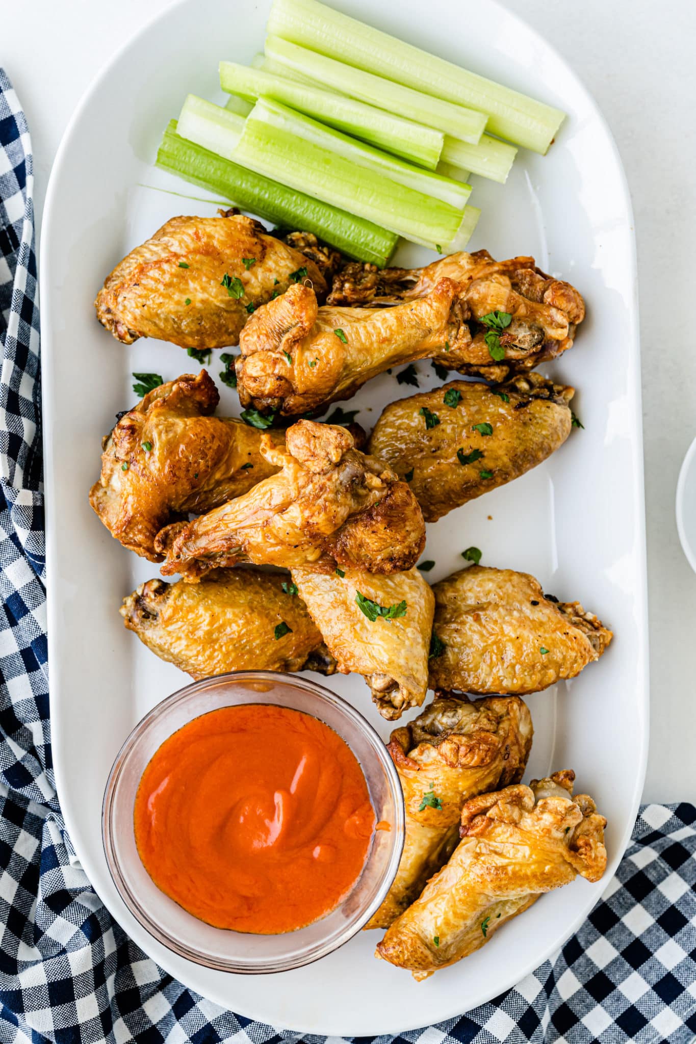 air fryer frozen chicken wings served with buffalo sauce.