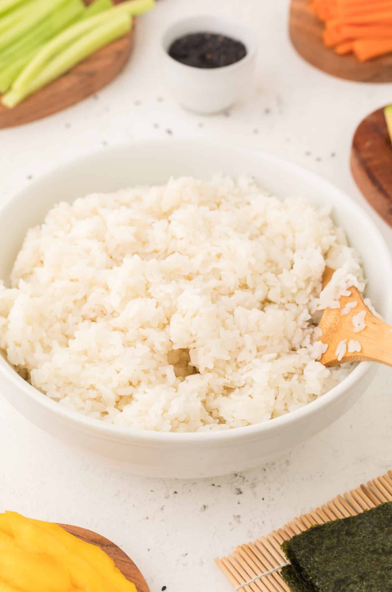 A bowl of cooked instant pot sushi rice on table.