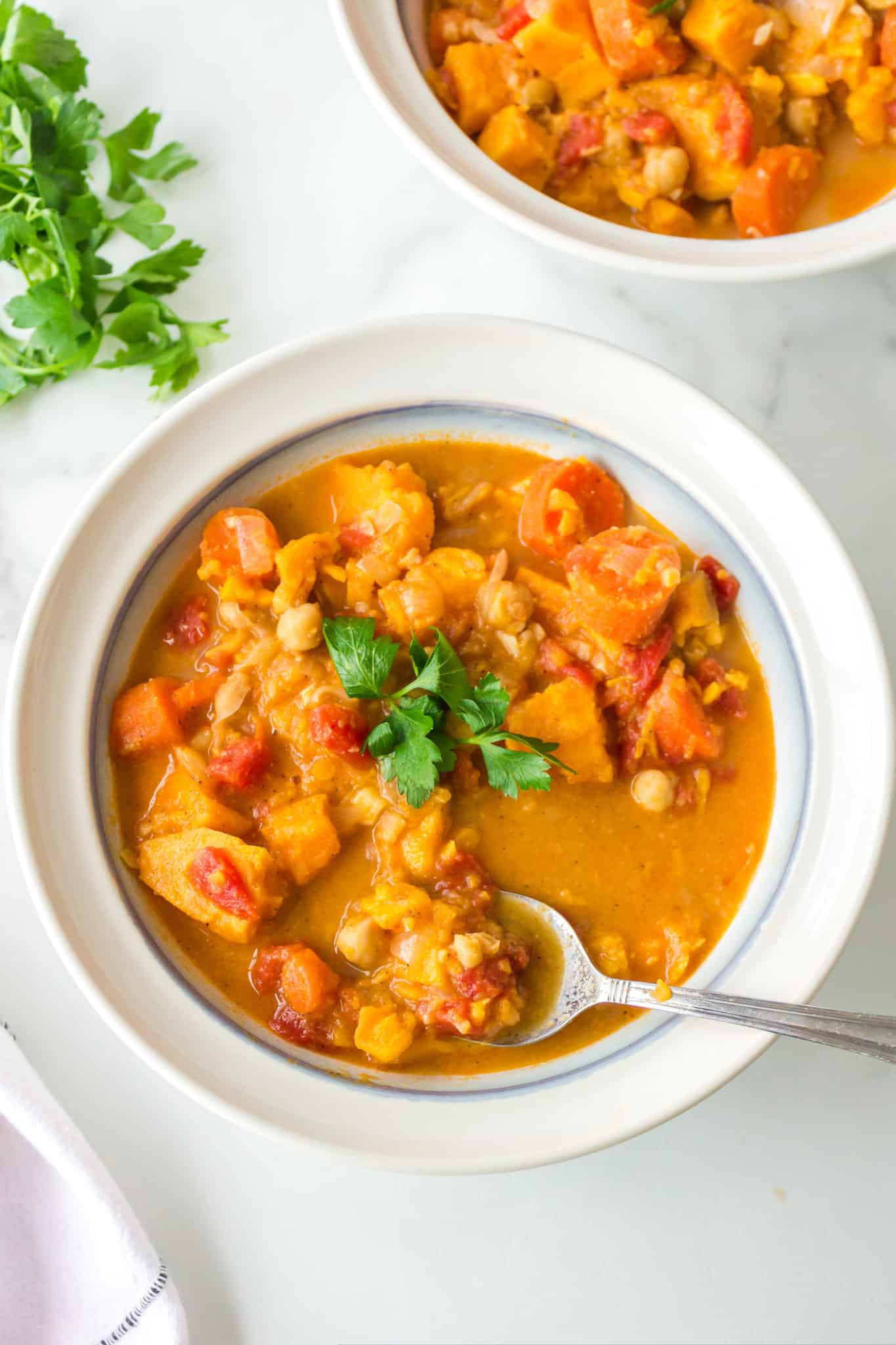 two bowls of vegan stew with cauliflower.