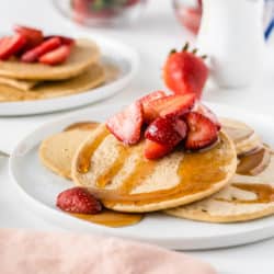 a plate of pancakes with strawberries