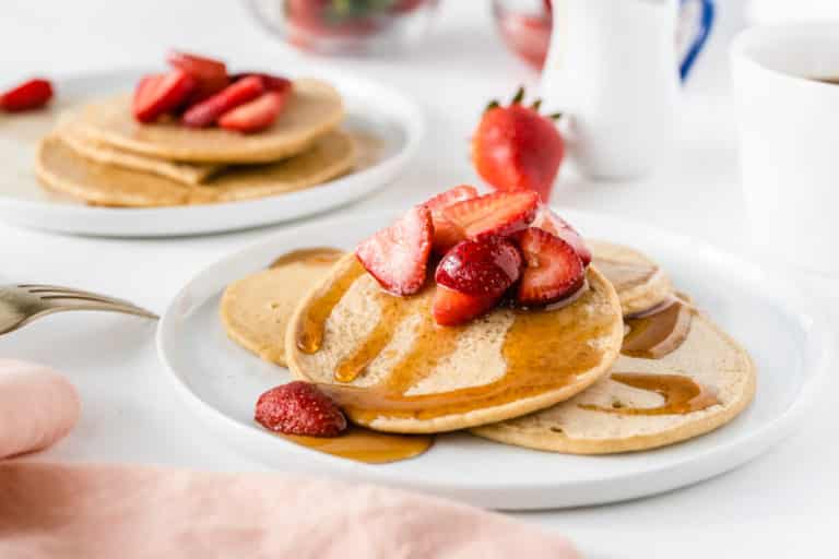 a plate of pancakes with strawberries