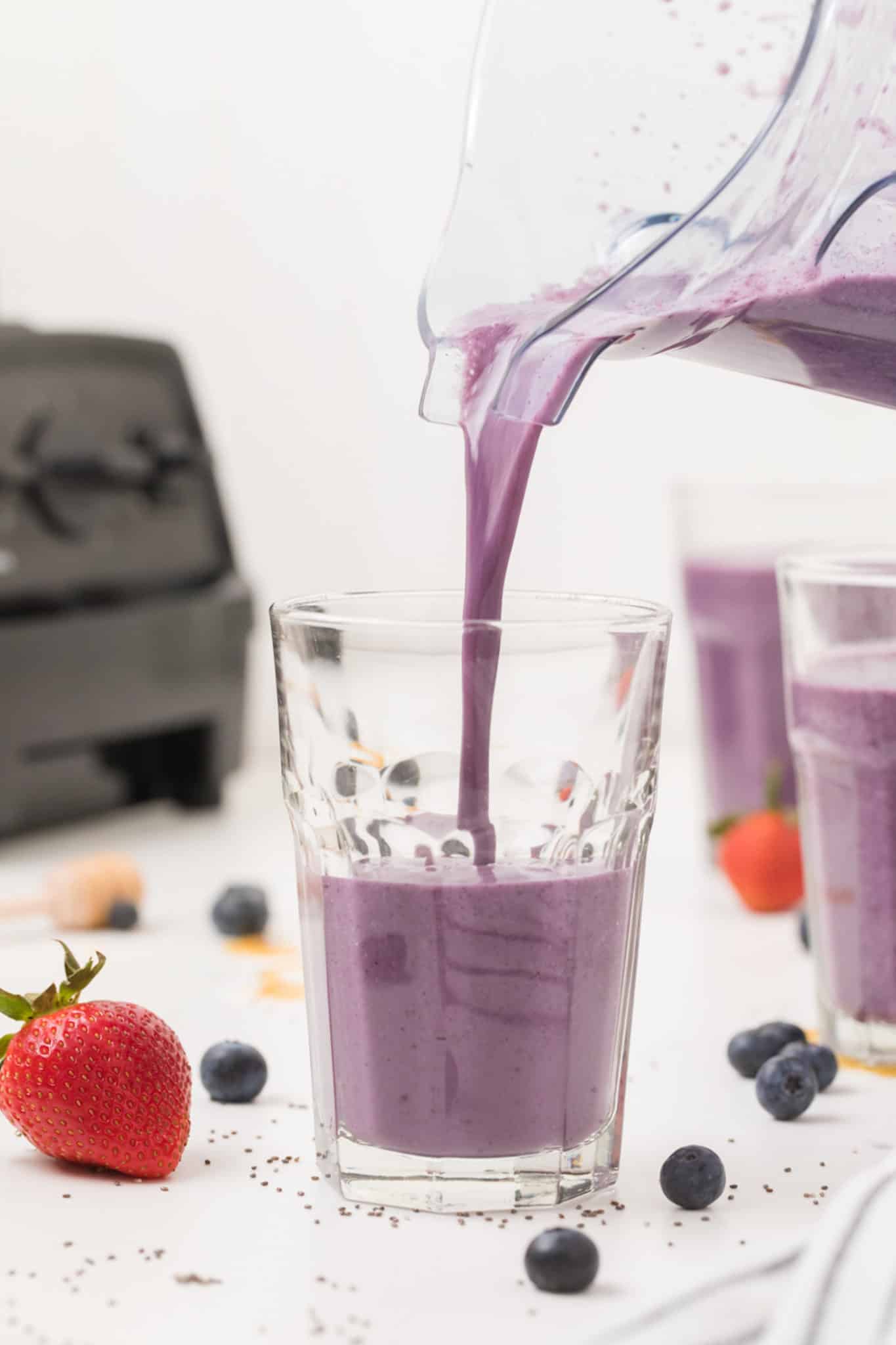 photo of pouring smoothie into a glass.