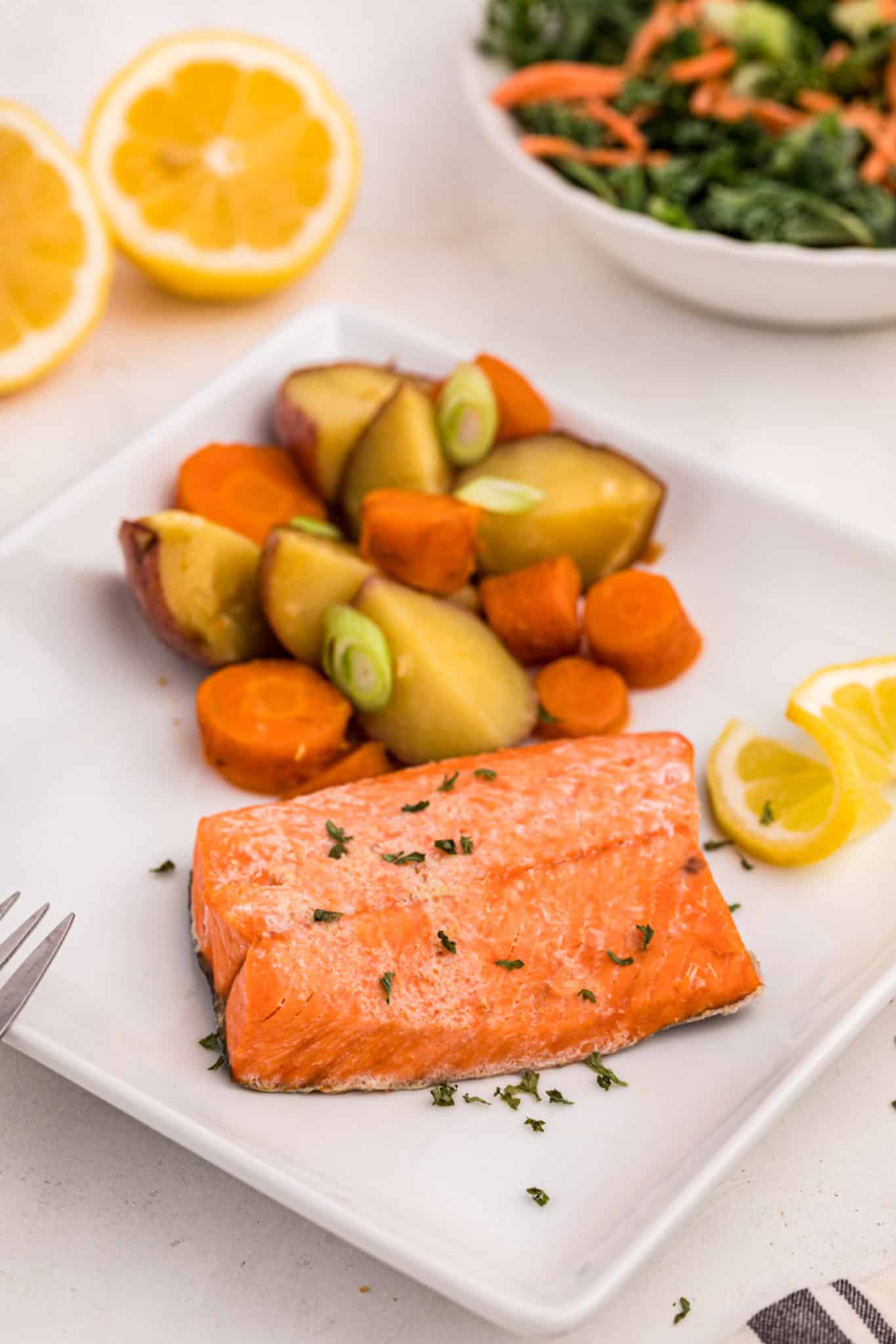 cooked salmon served with potatoes and carrots