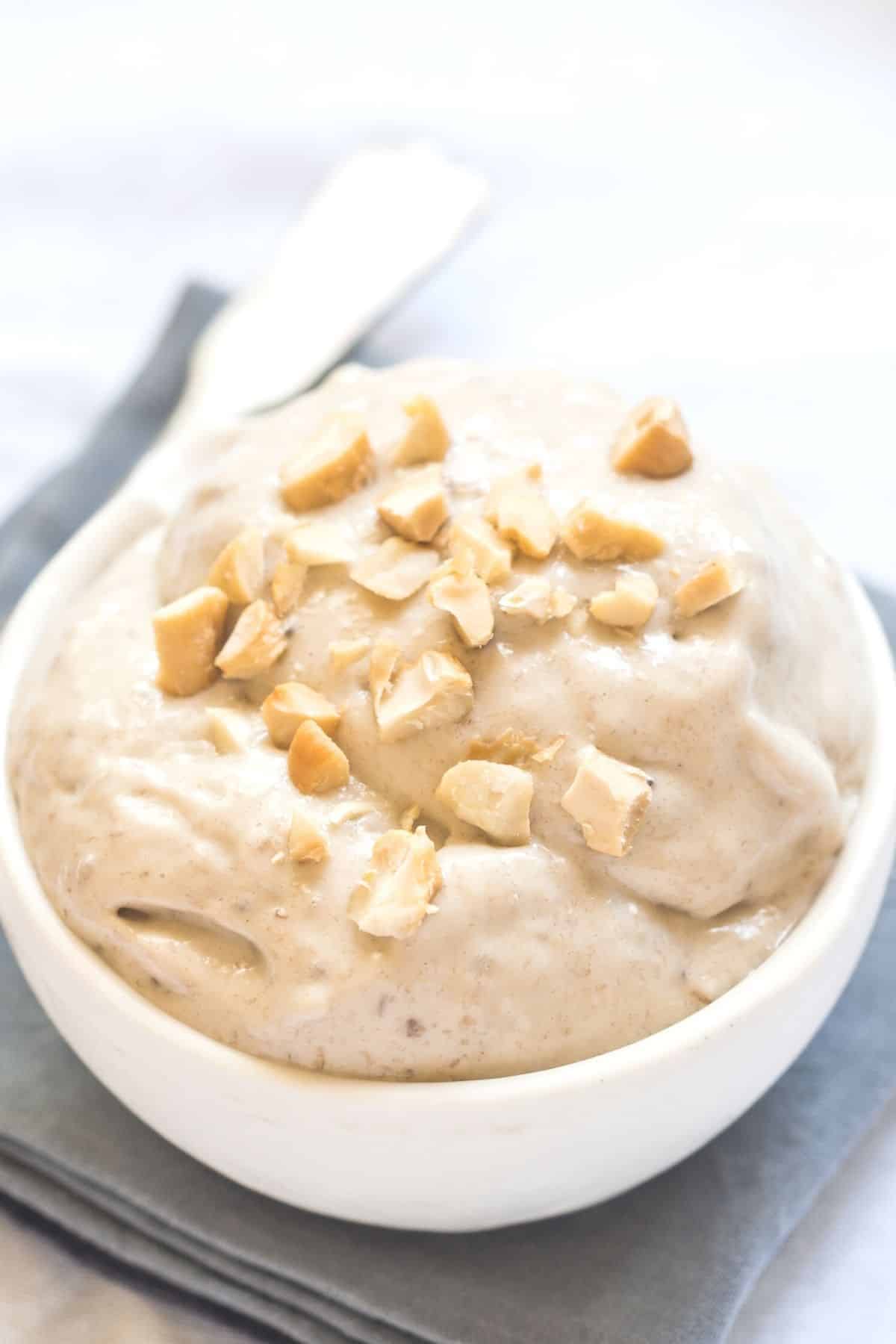 bowl of banana peanut butter nice cream in a white bowl with a spoon