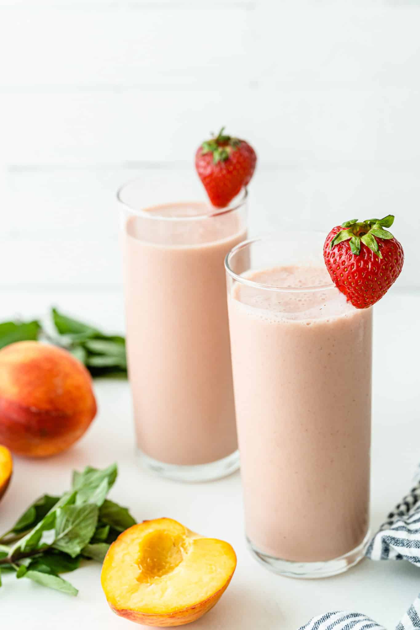 strawberry peach smoothies in two glasses.