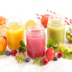 three colorful juices on a table