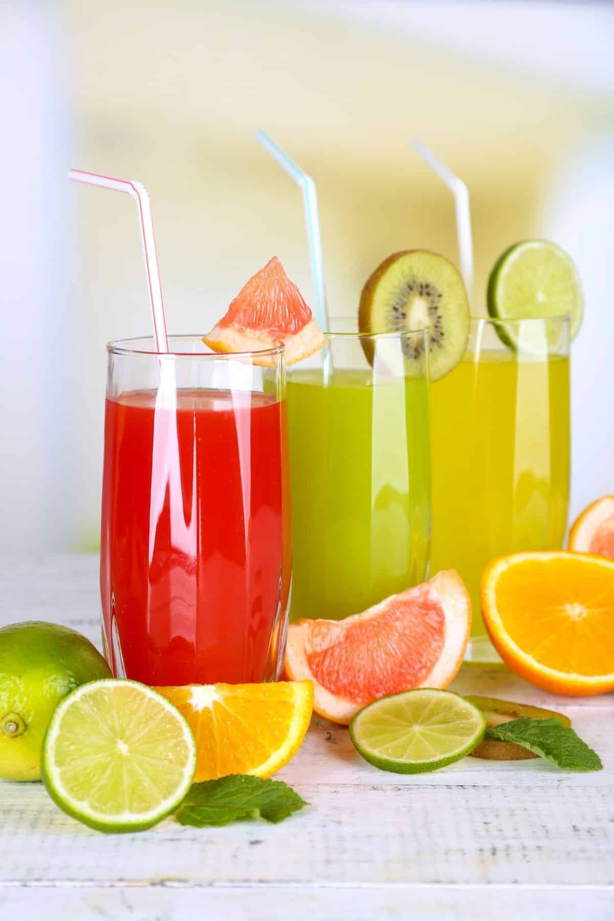 fresh fruit juices in glasses on a table.