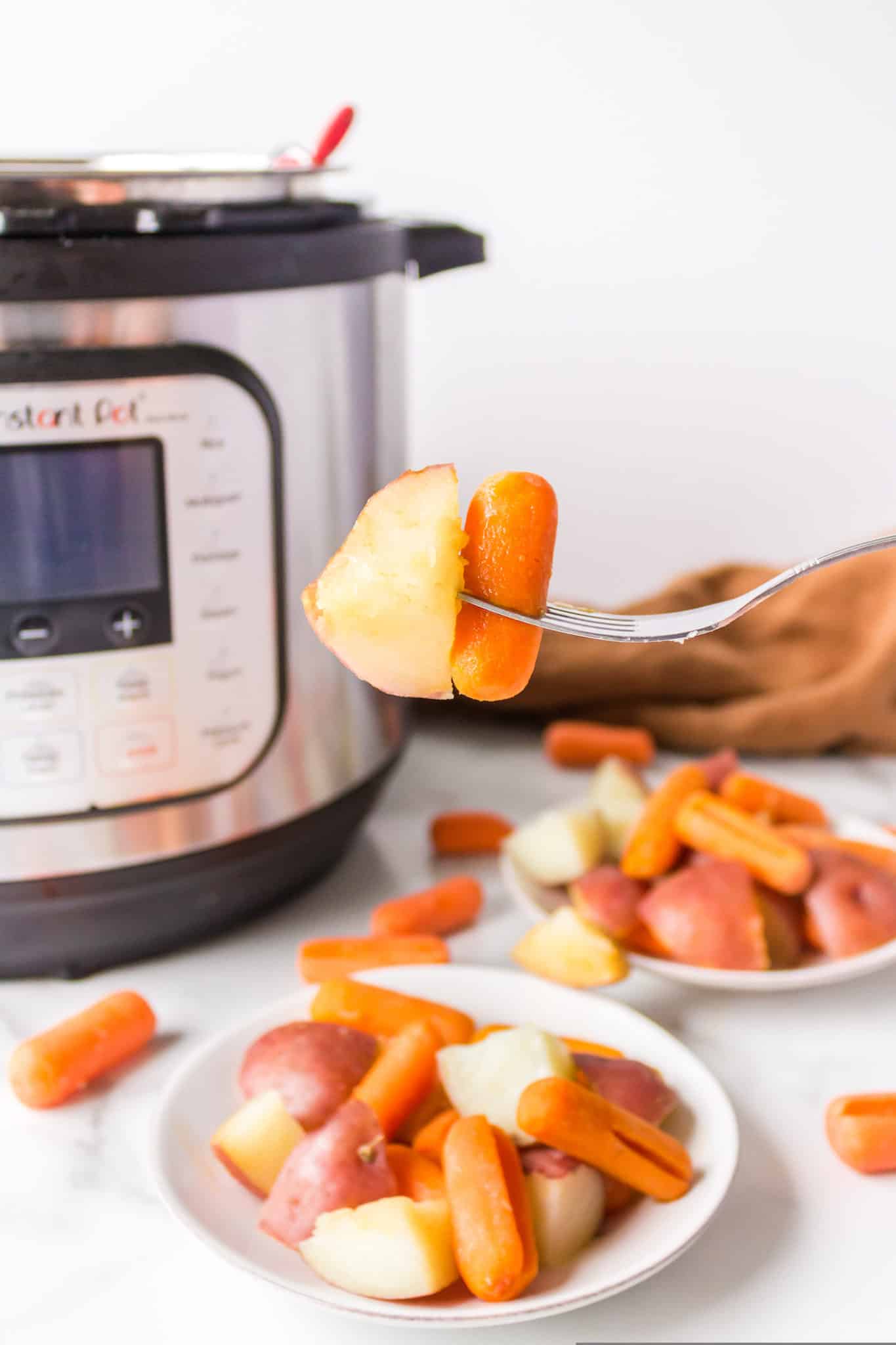 a bite of potatoes and carrots made in the instant pot pressure cooker.
