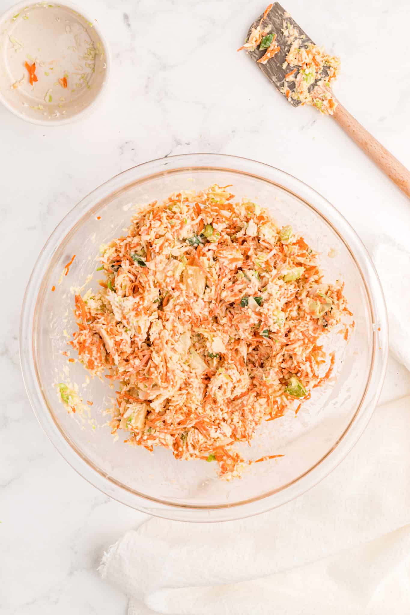 whole30 coleslaw stirred in a bowl with carrots.