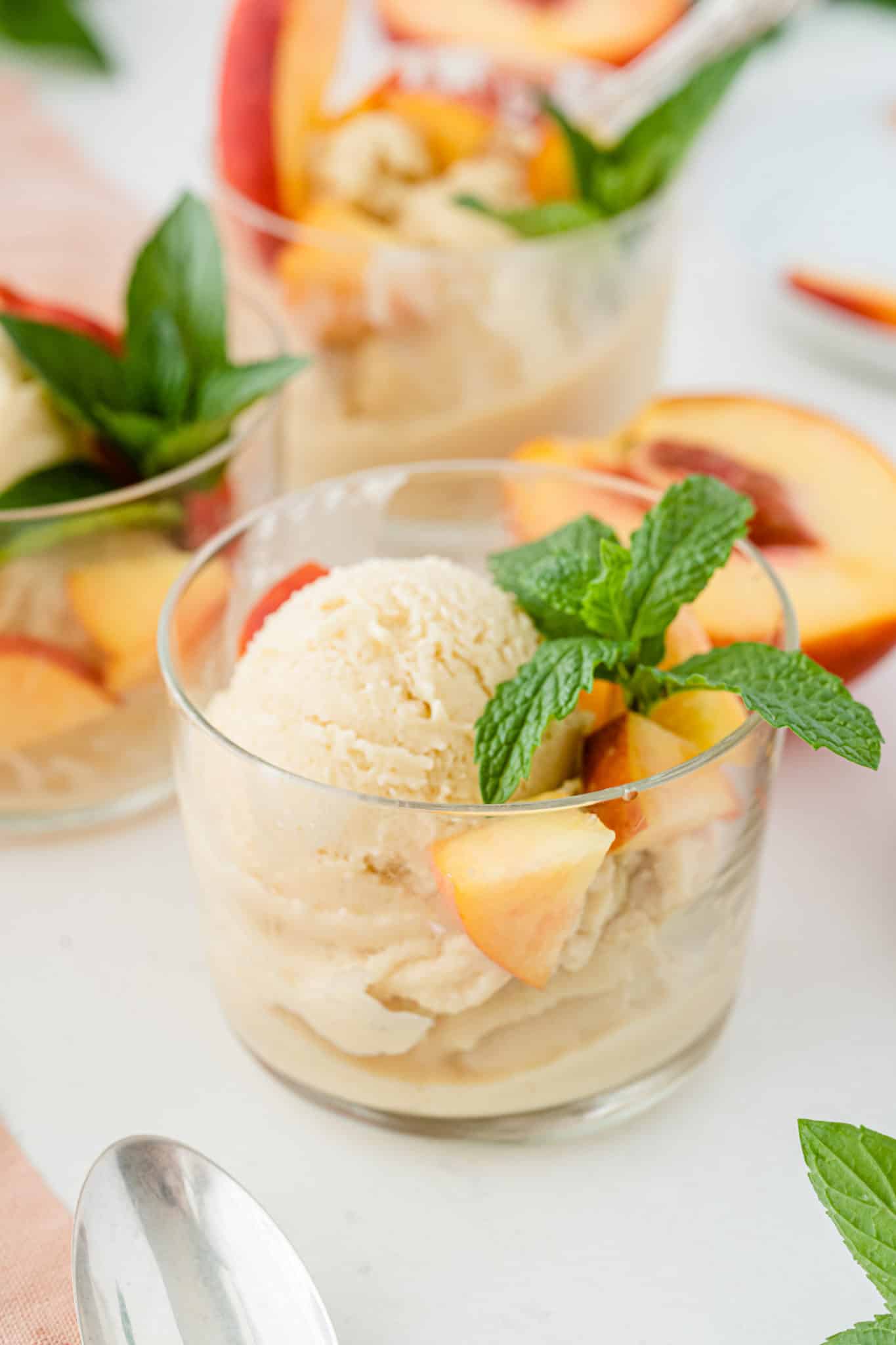 bowl of vegan peach ice cream with fresh mint
