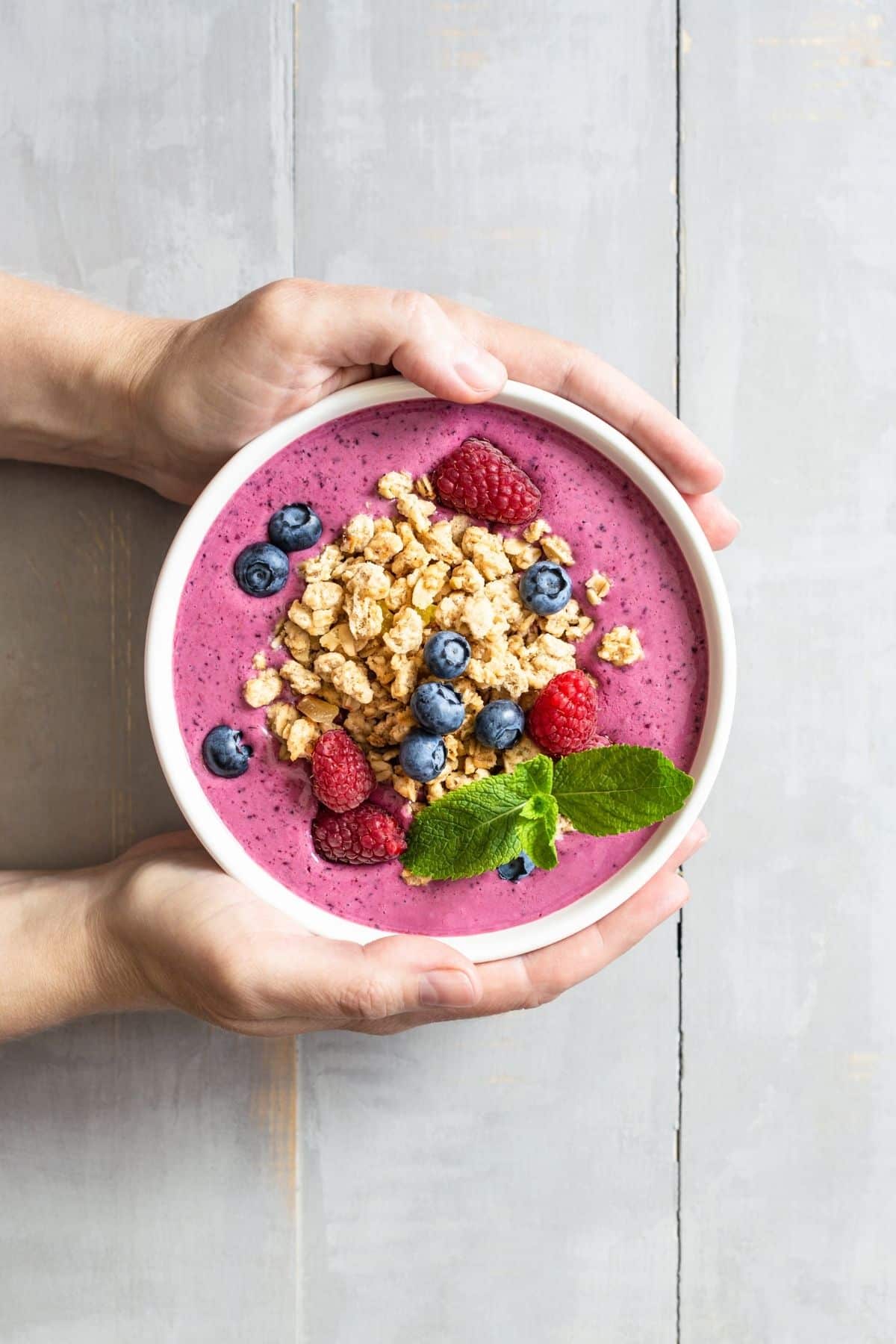 healthy fruit smoothie bowl topped with granola.