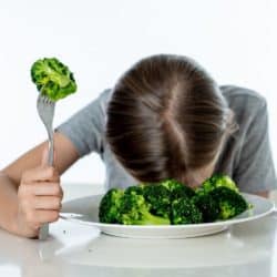 child with bowl of broccoli