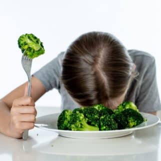 child with bowl of broccoli