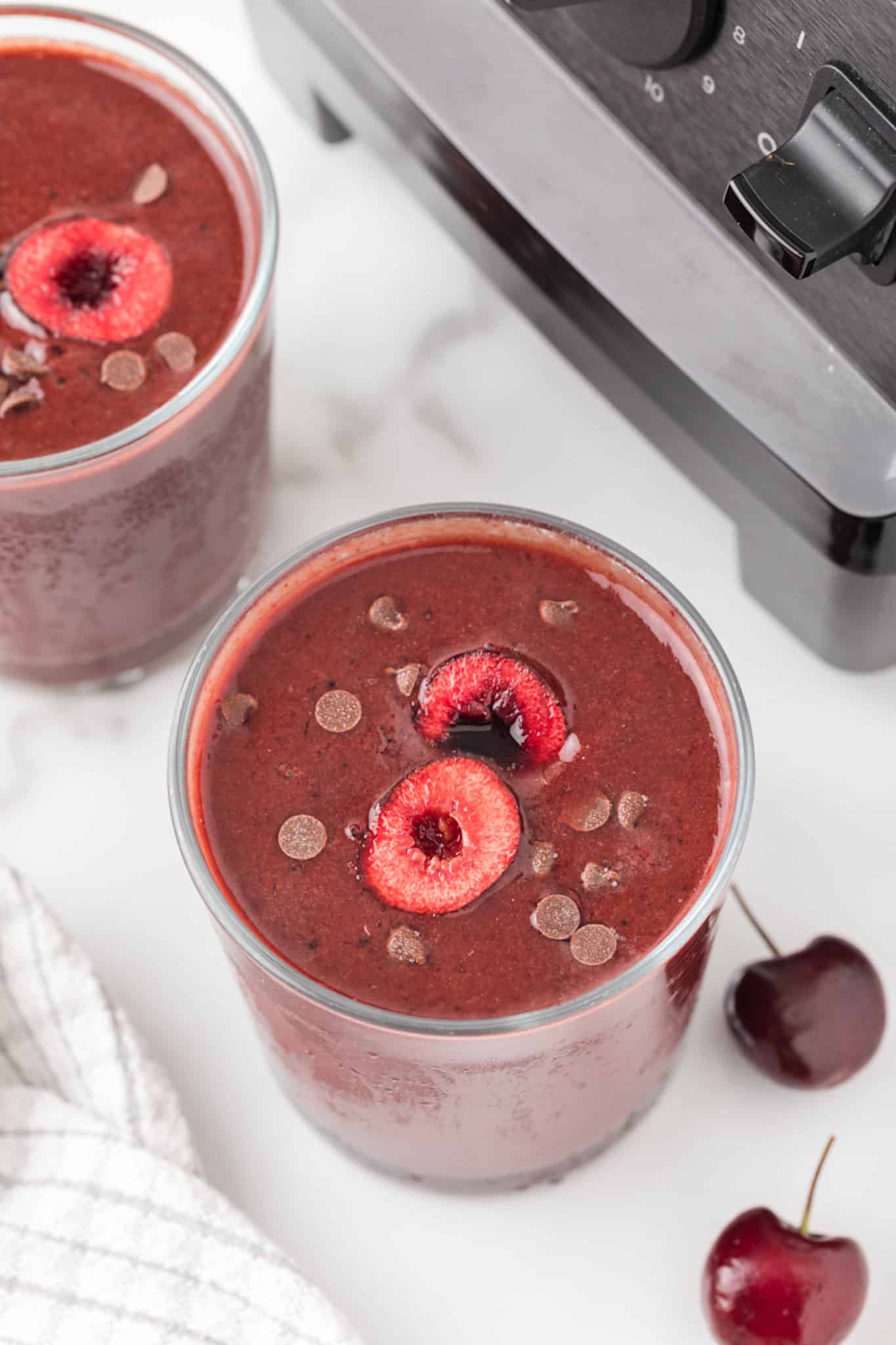 chocolate cherry smoothie served in two glasses.