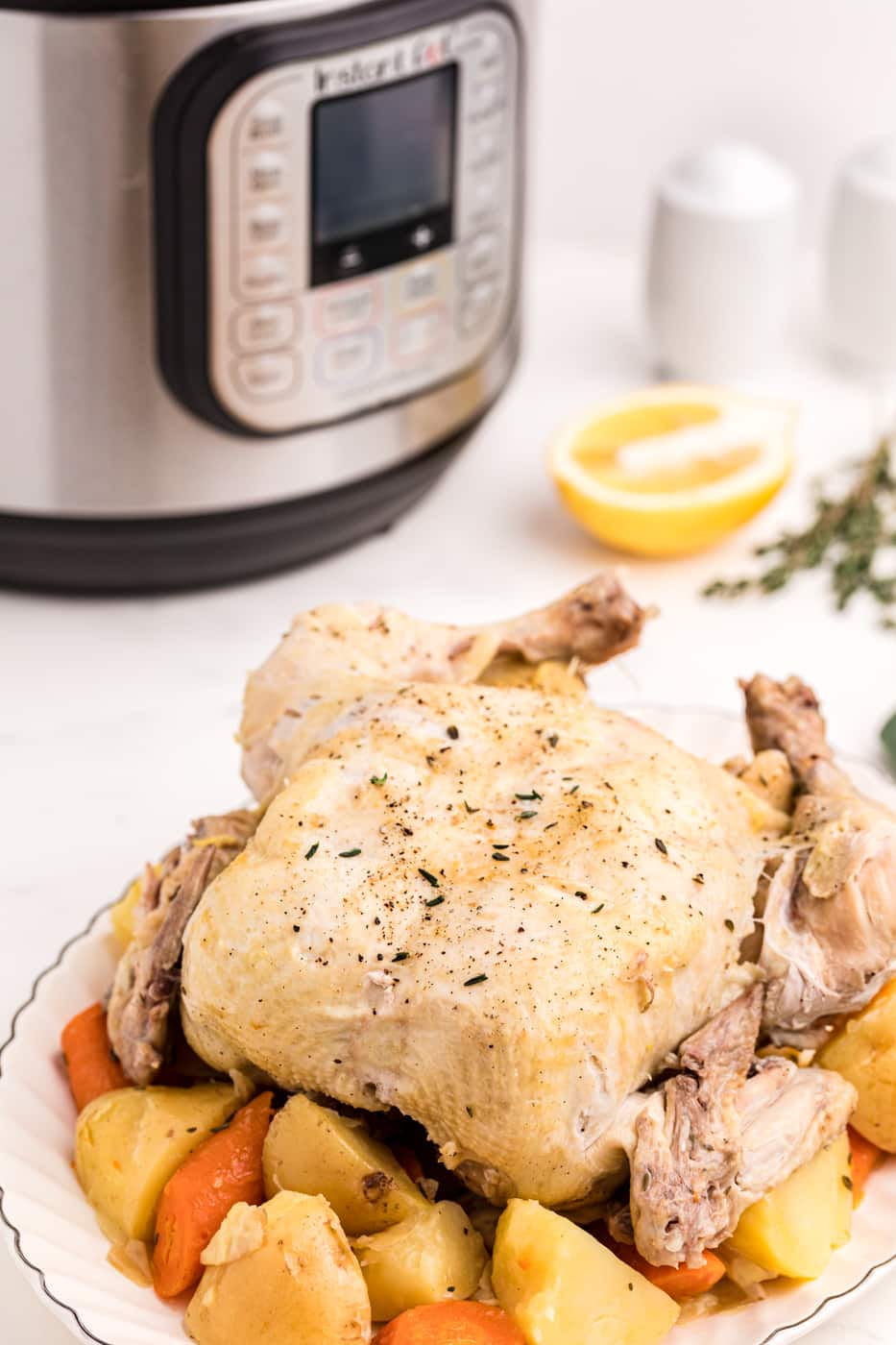 whole chicken with potatoes and carrots.