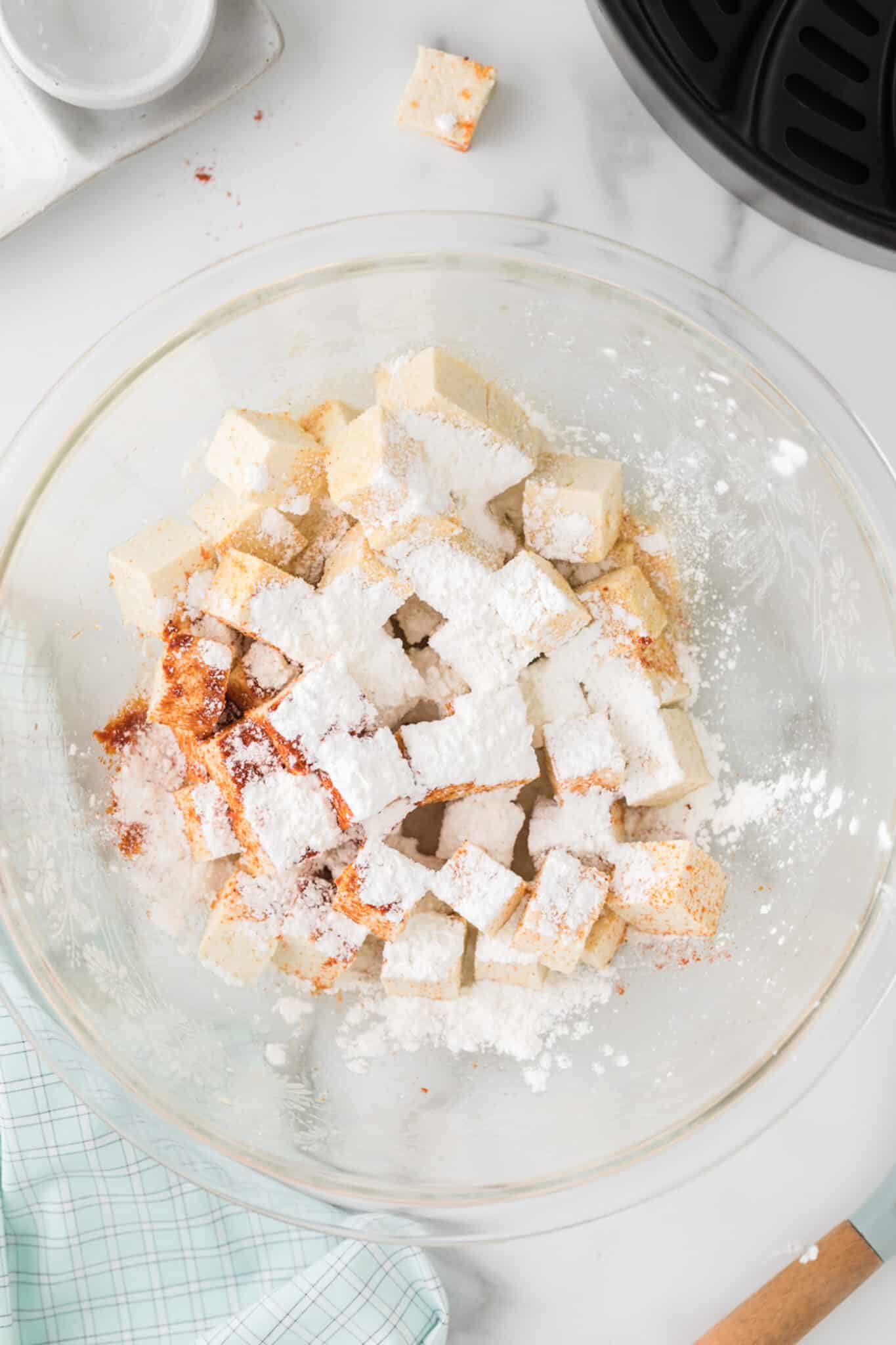chopped tofu in bowl with spices.