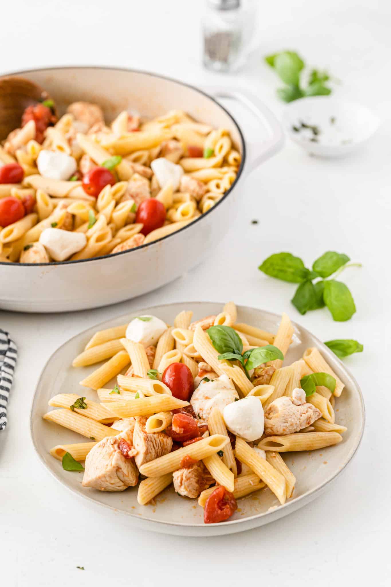 plate of pasta with fresh basil on top