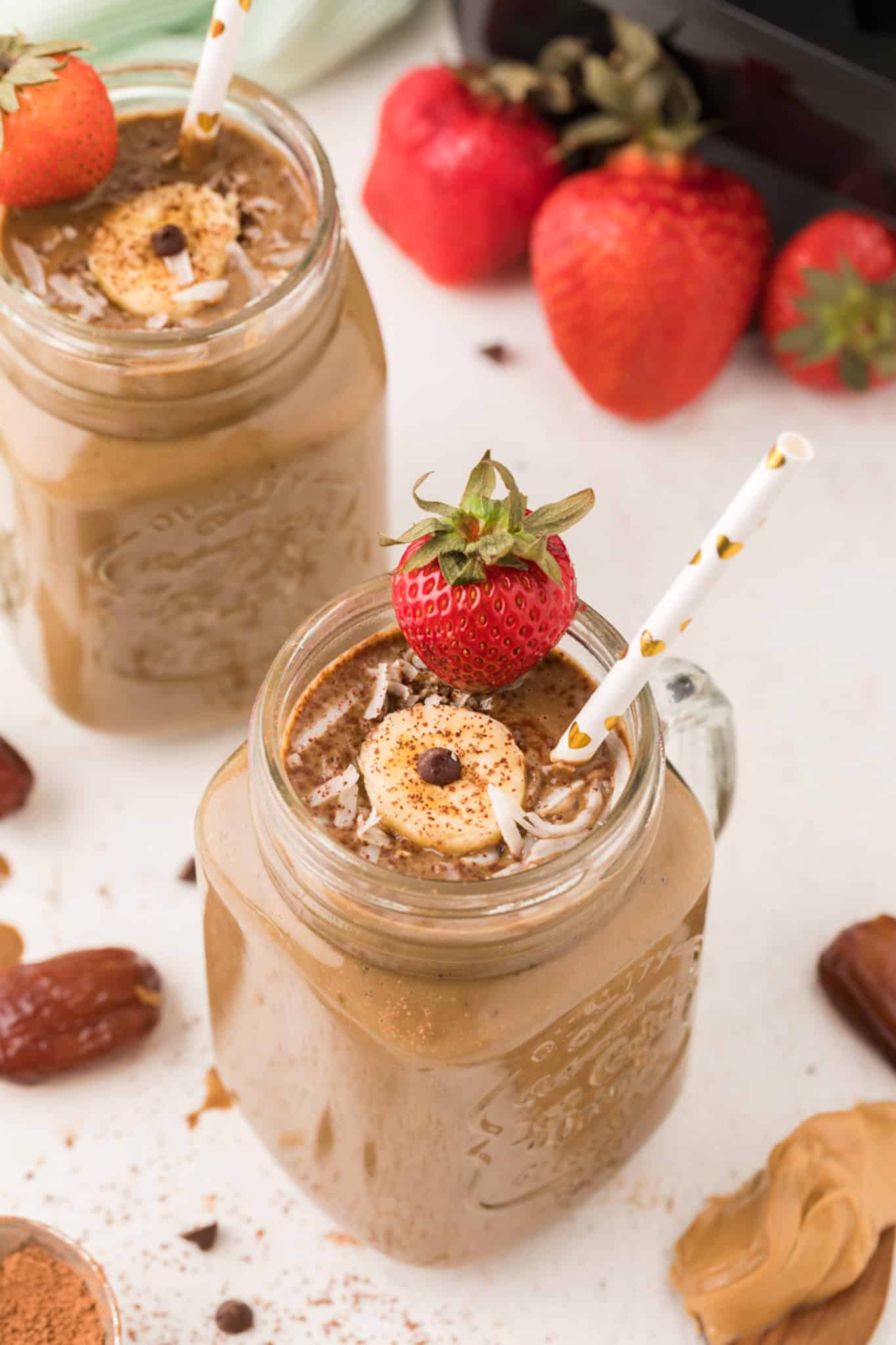 chocolate weight gain smoothie with strawberries and banana served in a jar.