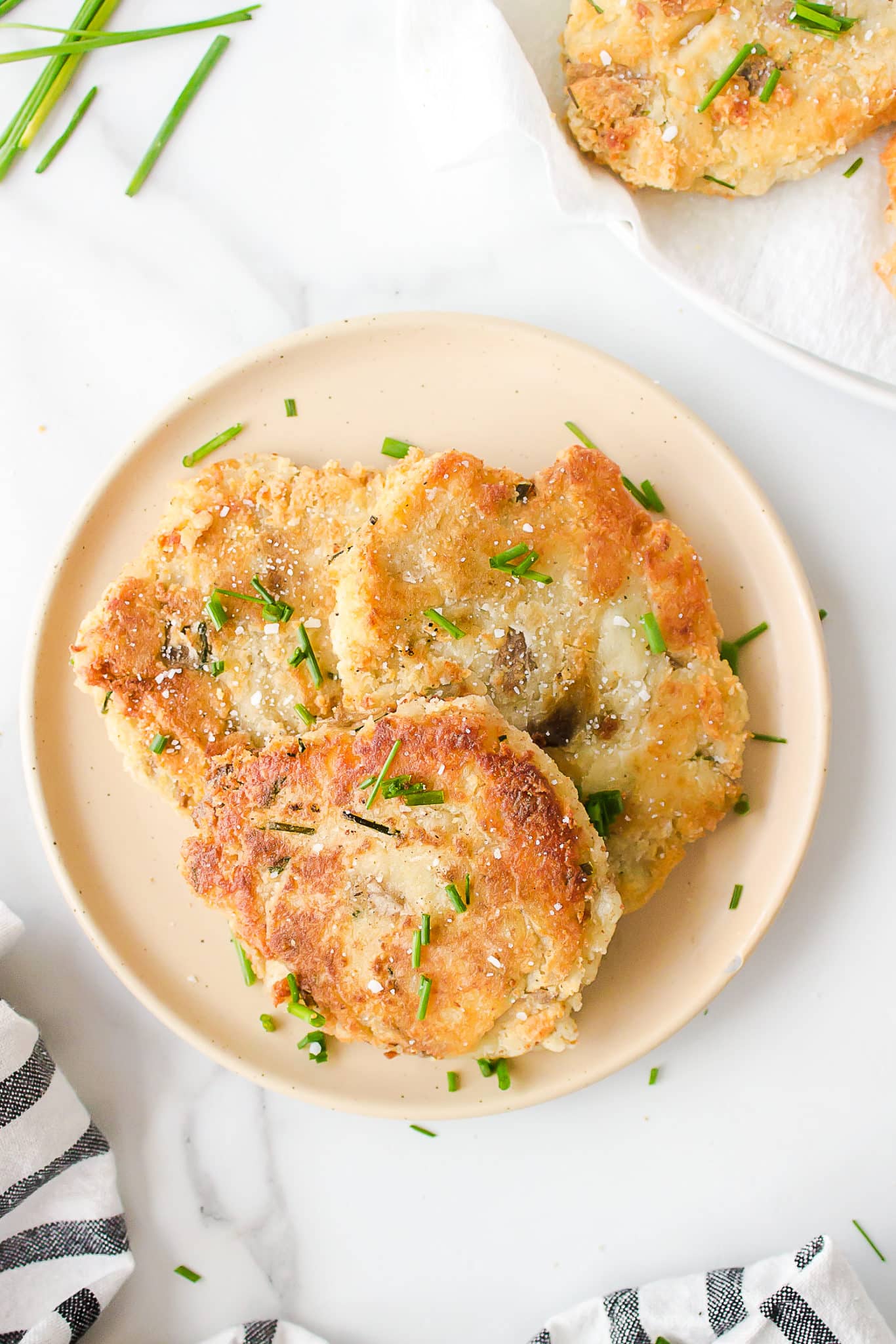 mashed potato fritters served on a plate.