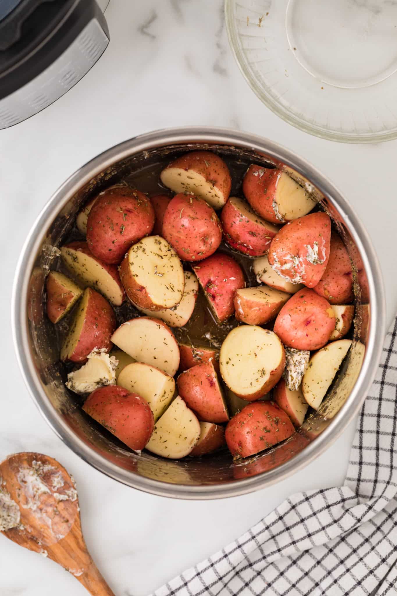 halved red potatoes inside instant pot pressure cooker.