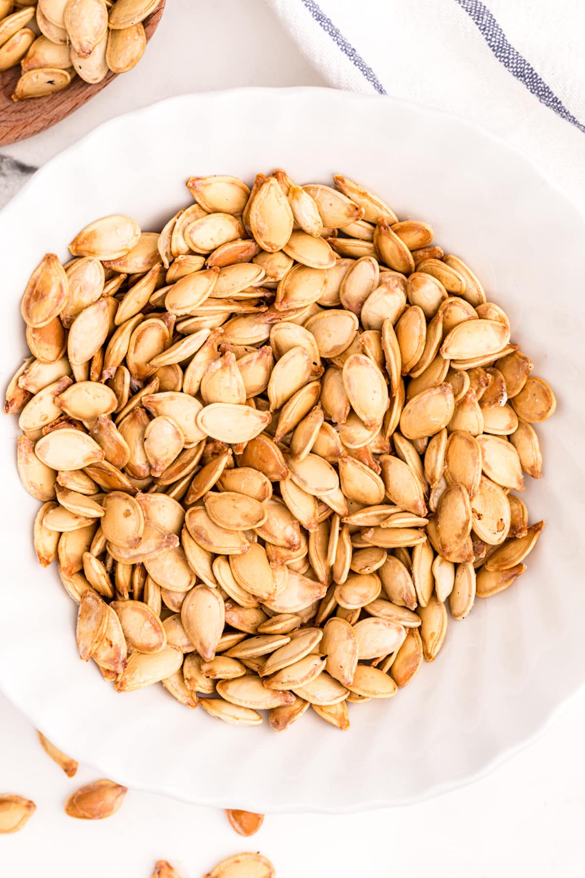 roasted air fryer pumpkin seeds served in a white bowl.