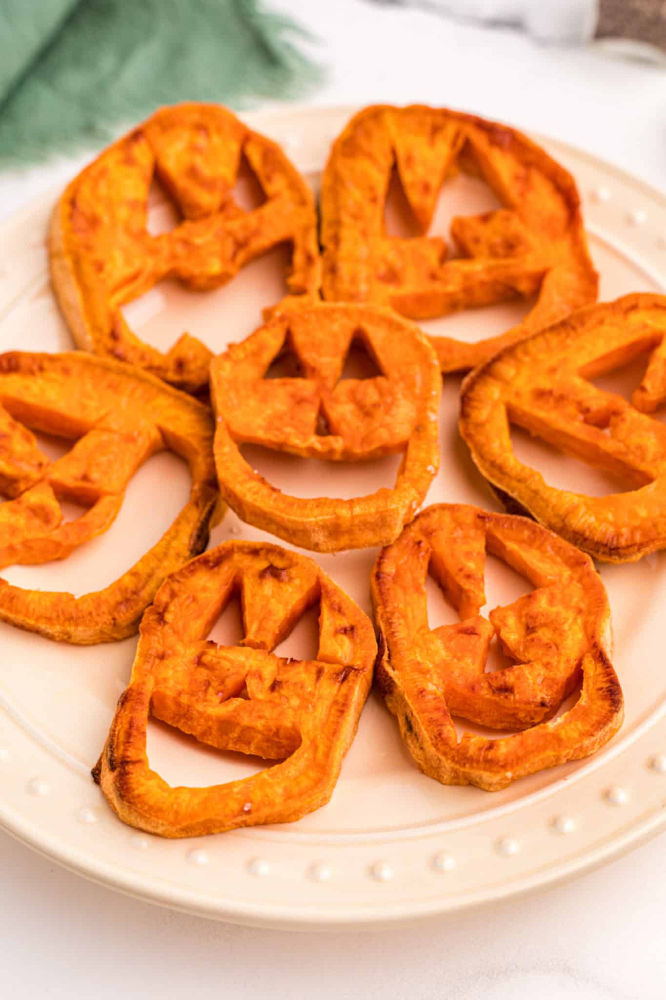 sweet potato jack o'lanterns on a plate.